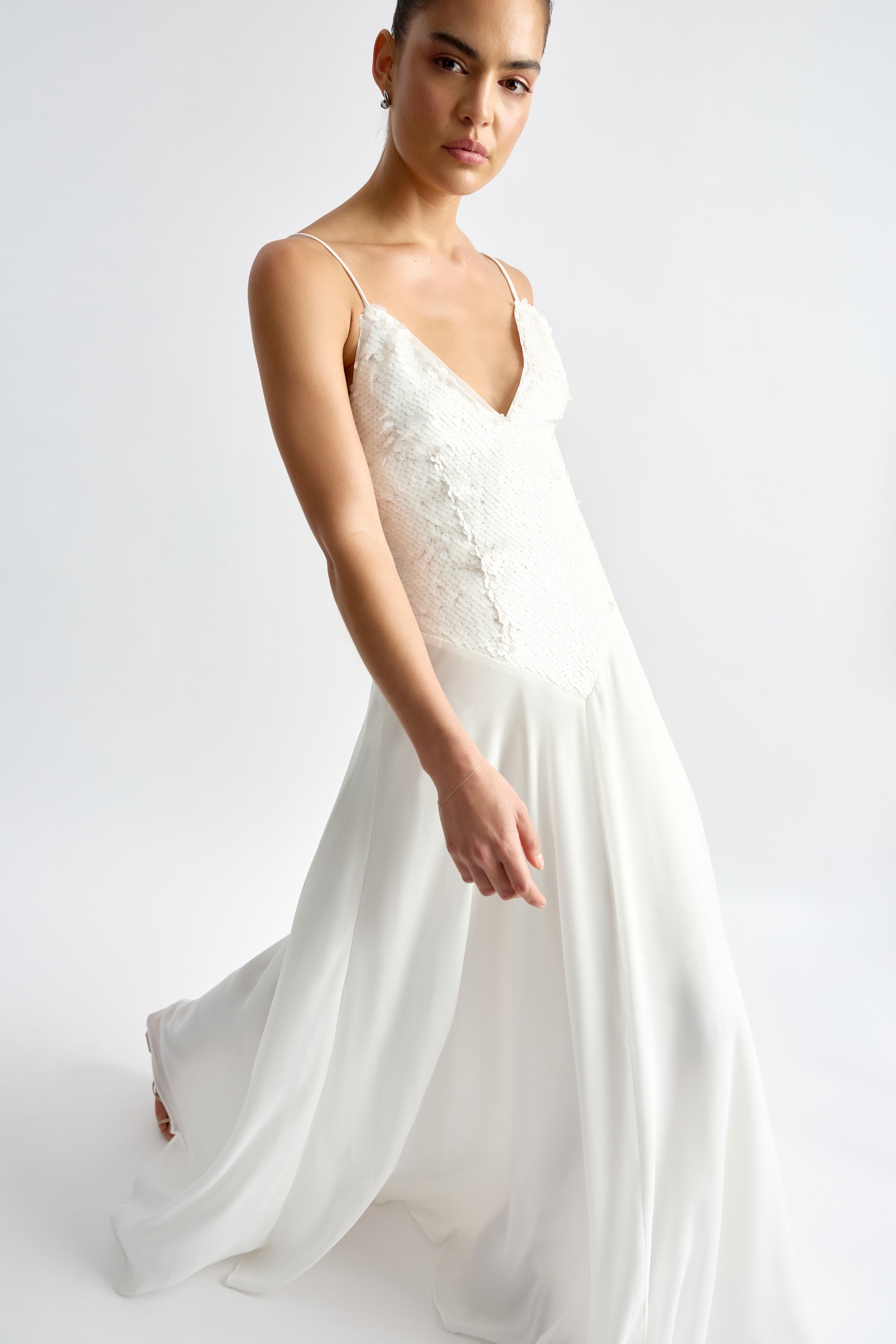 Leandre Dress featuring a sequin bodice with thin straps and flowing chiffon skirt in elegant ivory by Studio Lexi
