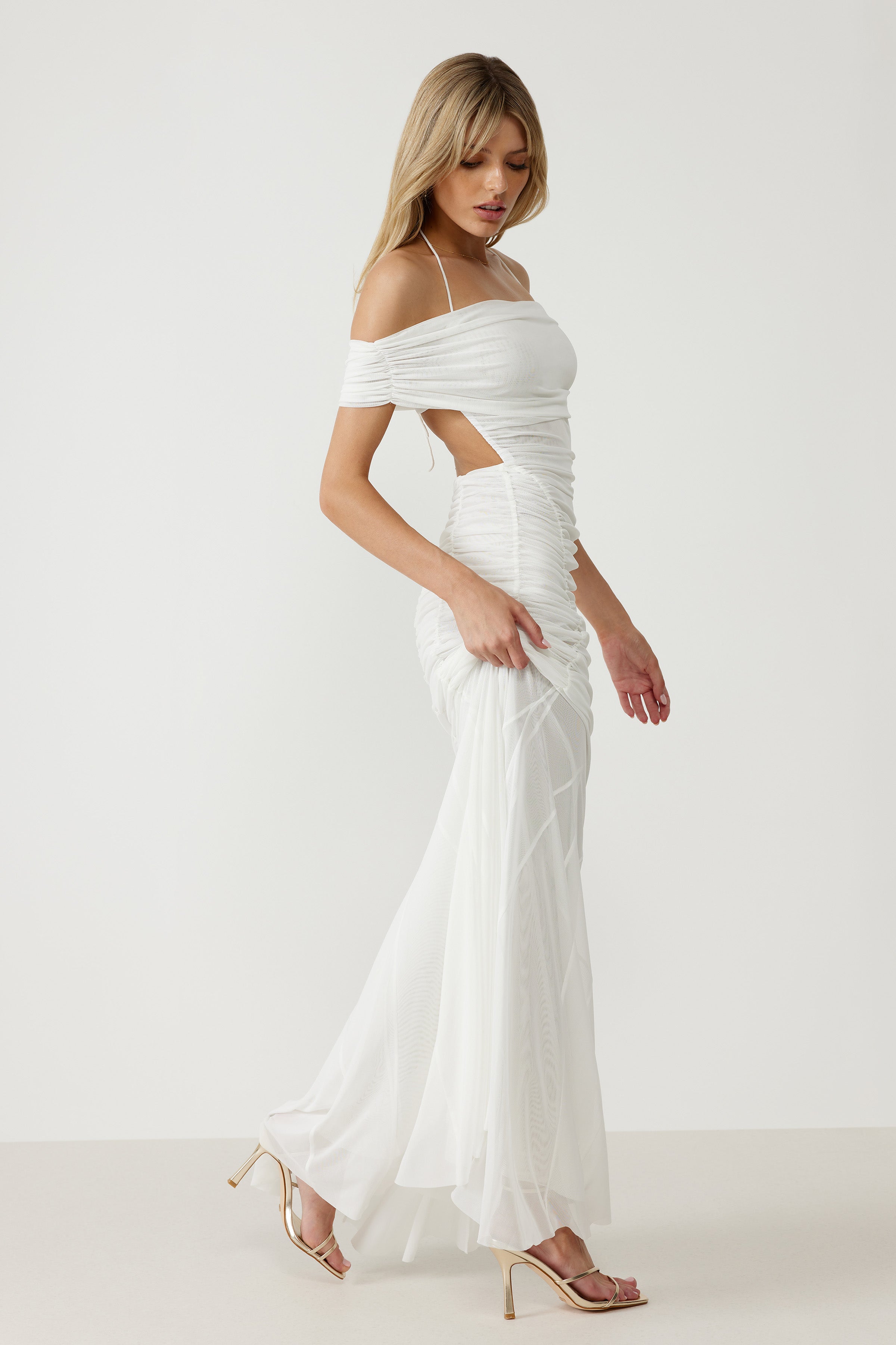 Livia Dress featuring off-shoulder neckline, cut-out sides, and small train in elegant white stretch mesh for formal wear
