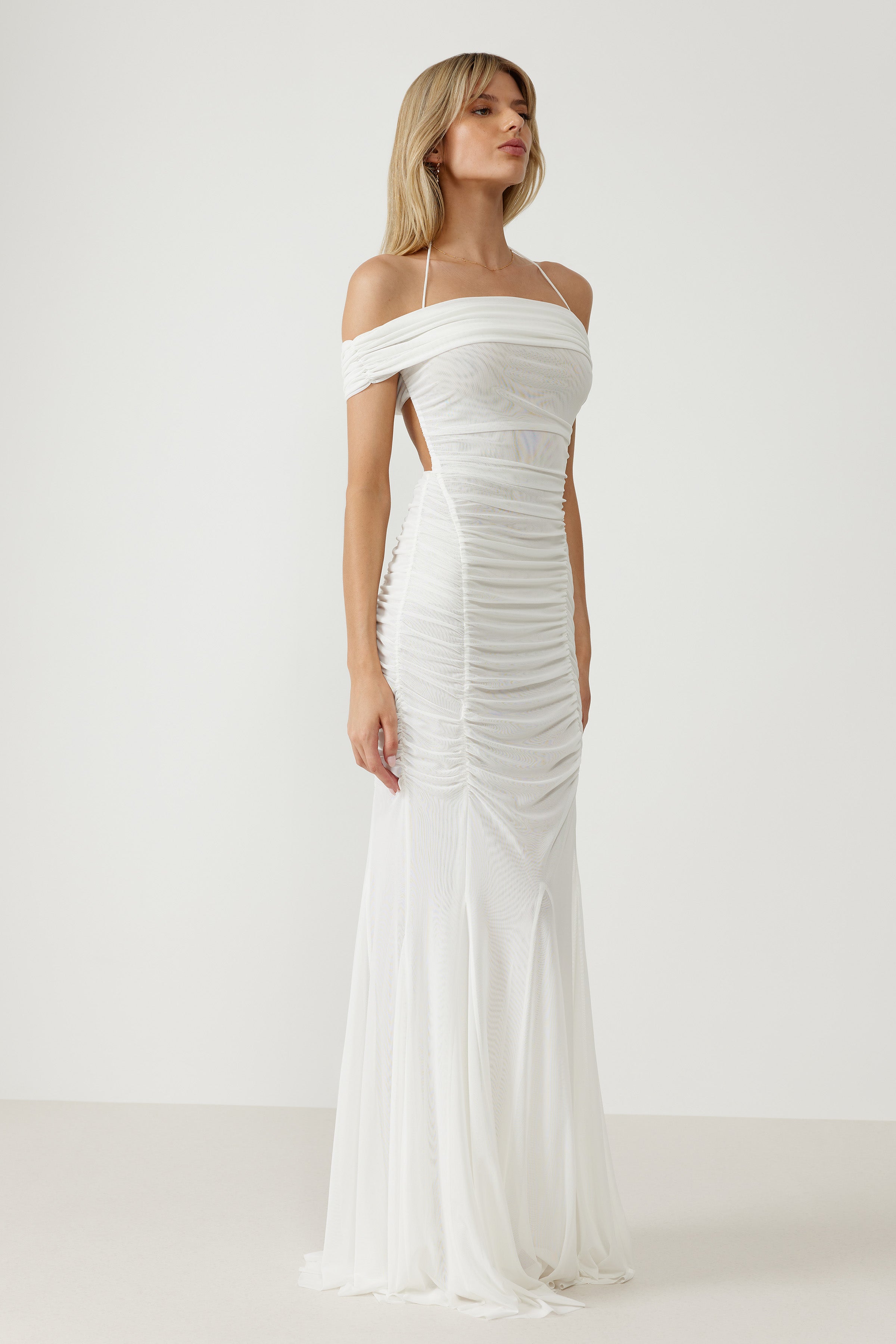 Livia Dress featuring off-shoulder neckline, ruched stretch mesh fabric, backless design, and small train in white for formal occasions