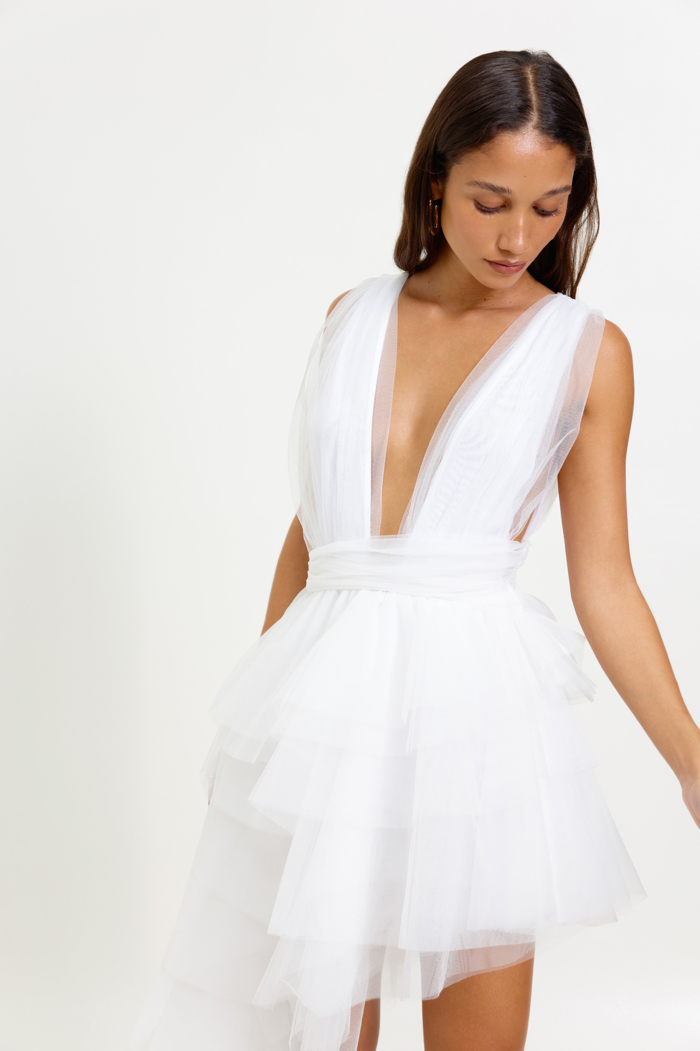 Lola Dress featuring a deep V neckline and tiered tulle skirt with small train in white for cocktail occasions