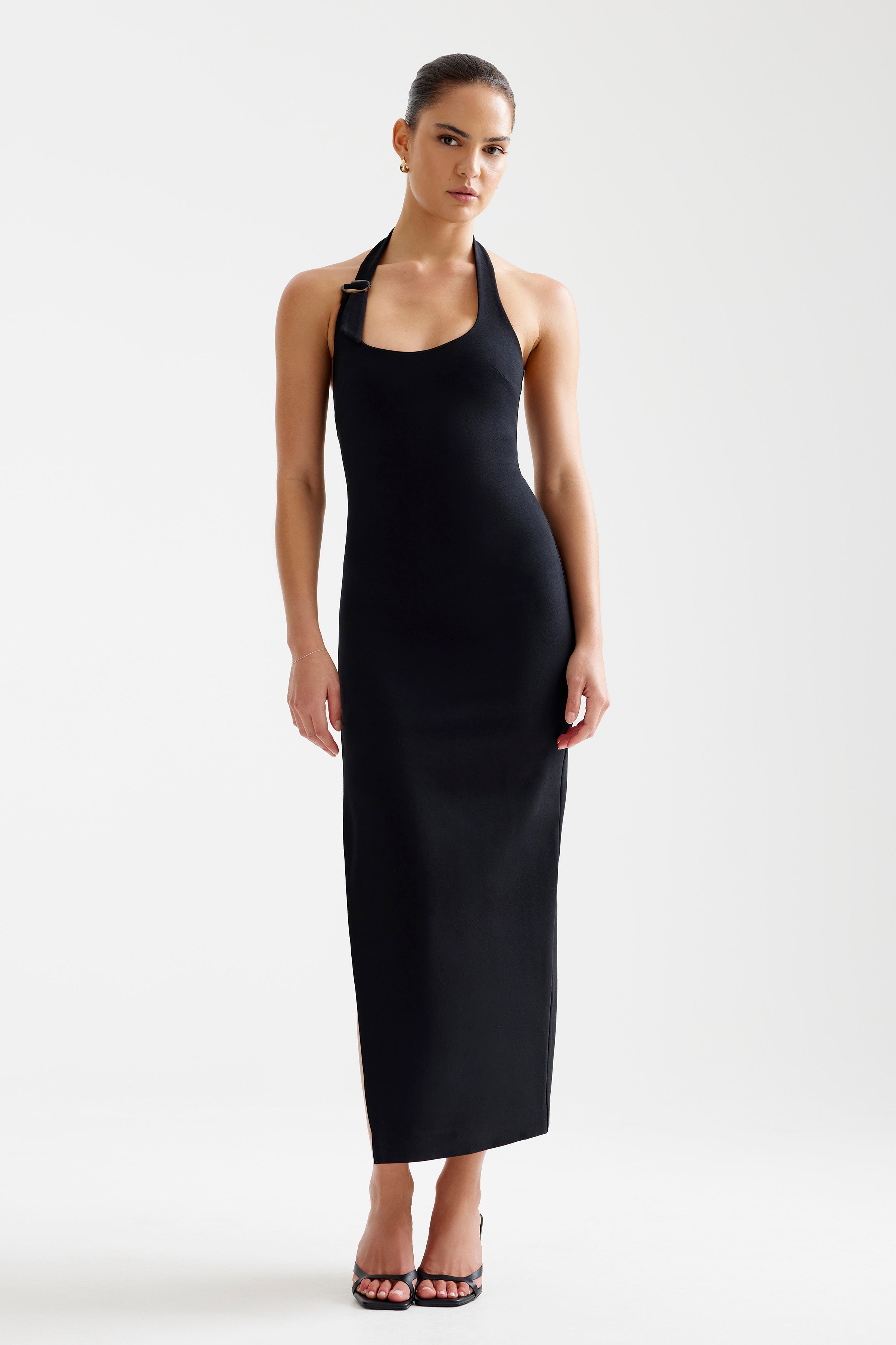 Luna Dress featuring a sleek fitted silhouette with a halter neckline and buckle detail in black by Studio Lexi