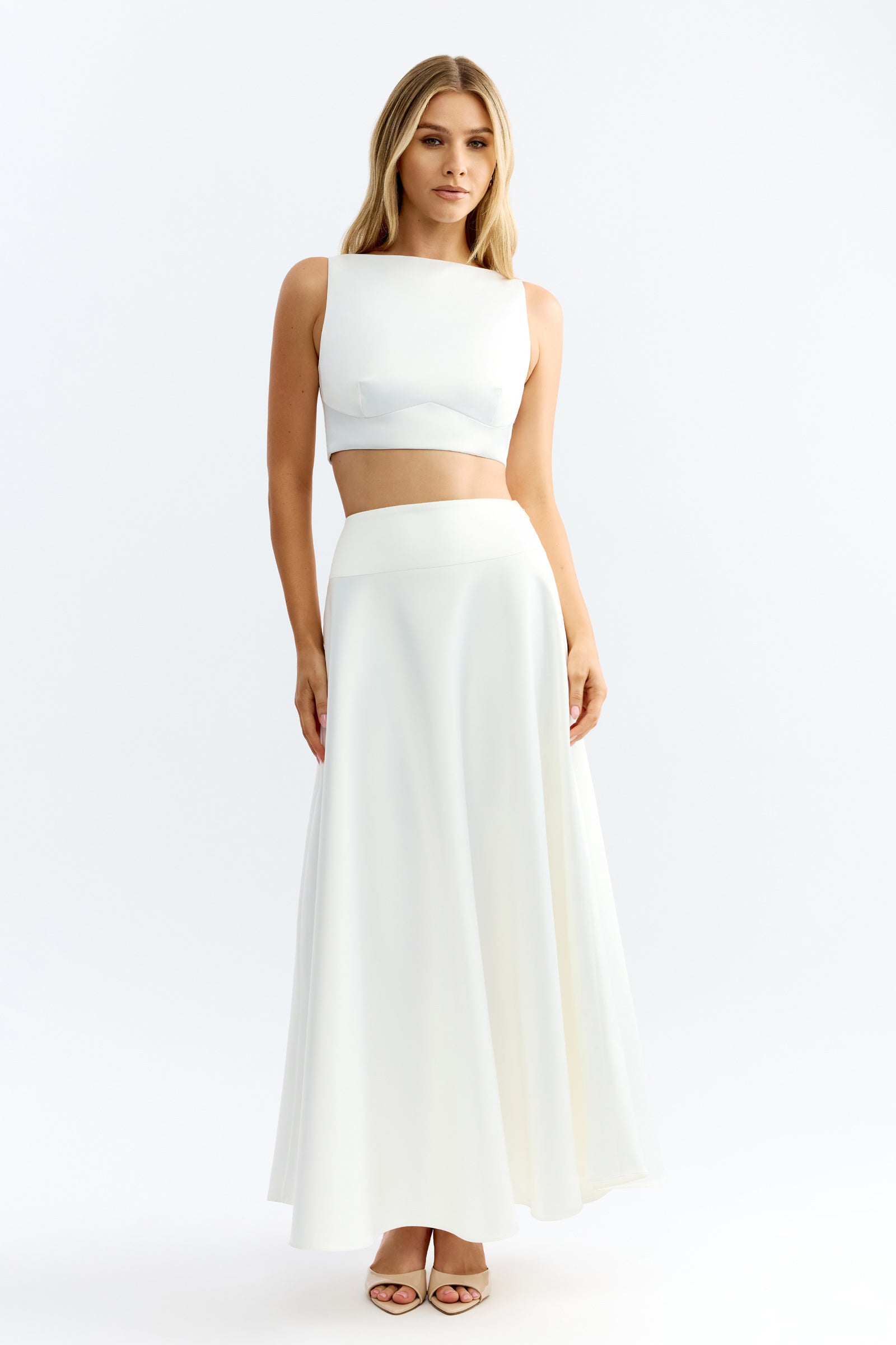 Lydia Set featuring a sleeveless crop top and long flowing skirt in ivory satin fabric by Studio Lexi