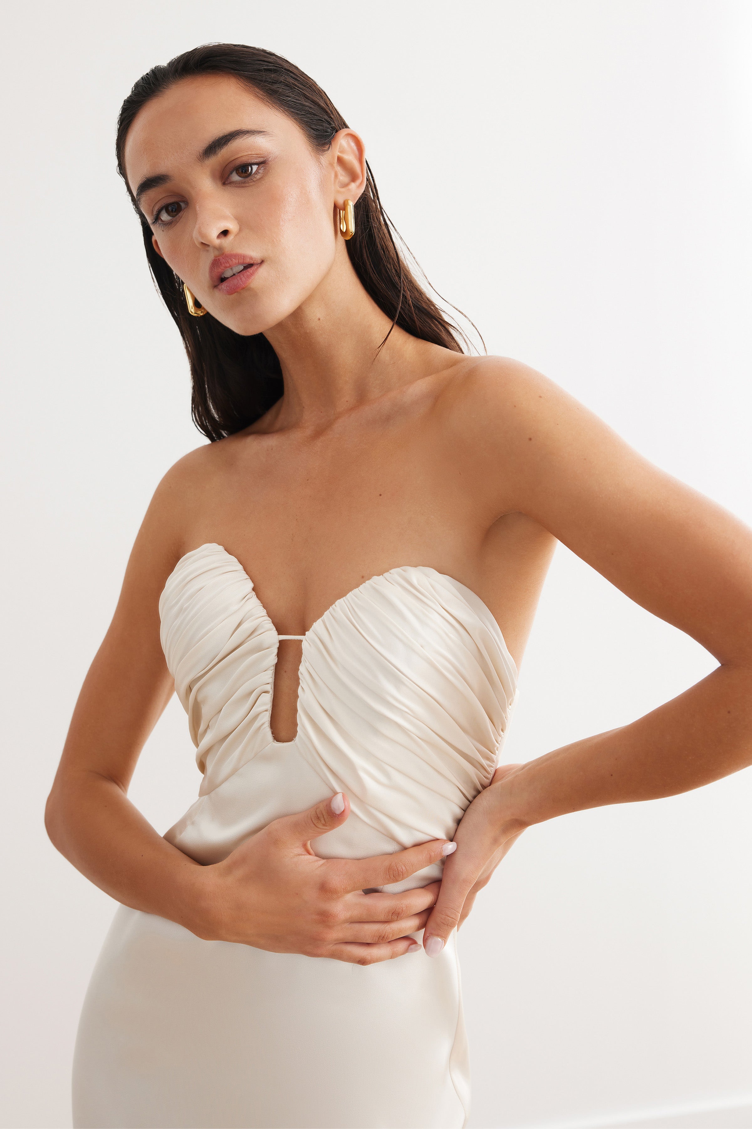 Magnolia Dress featuring a strapless ruched bodice with a plunging neckline in oyster satin for formal events