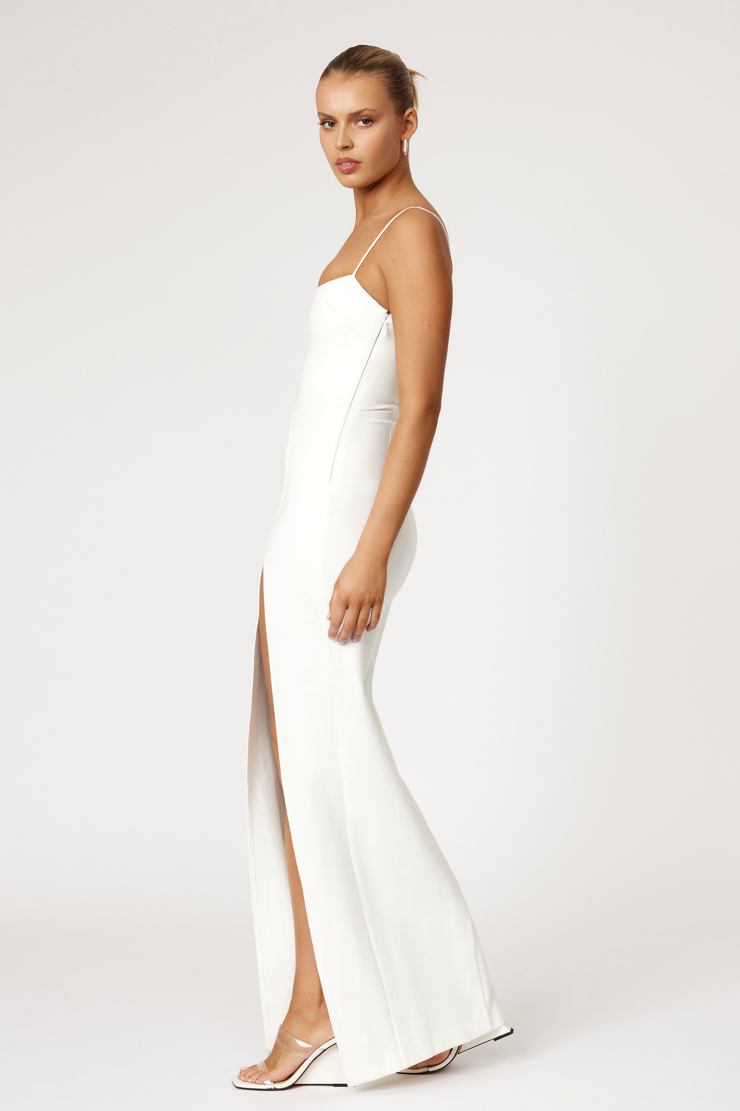 Mara Dress sleek fitted silhouette with thin straps and front split in white for formal, cocktail, and bridesmaid occasions by Studio Lexi