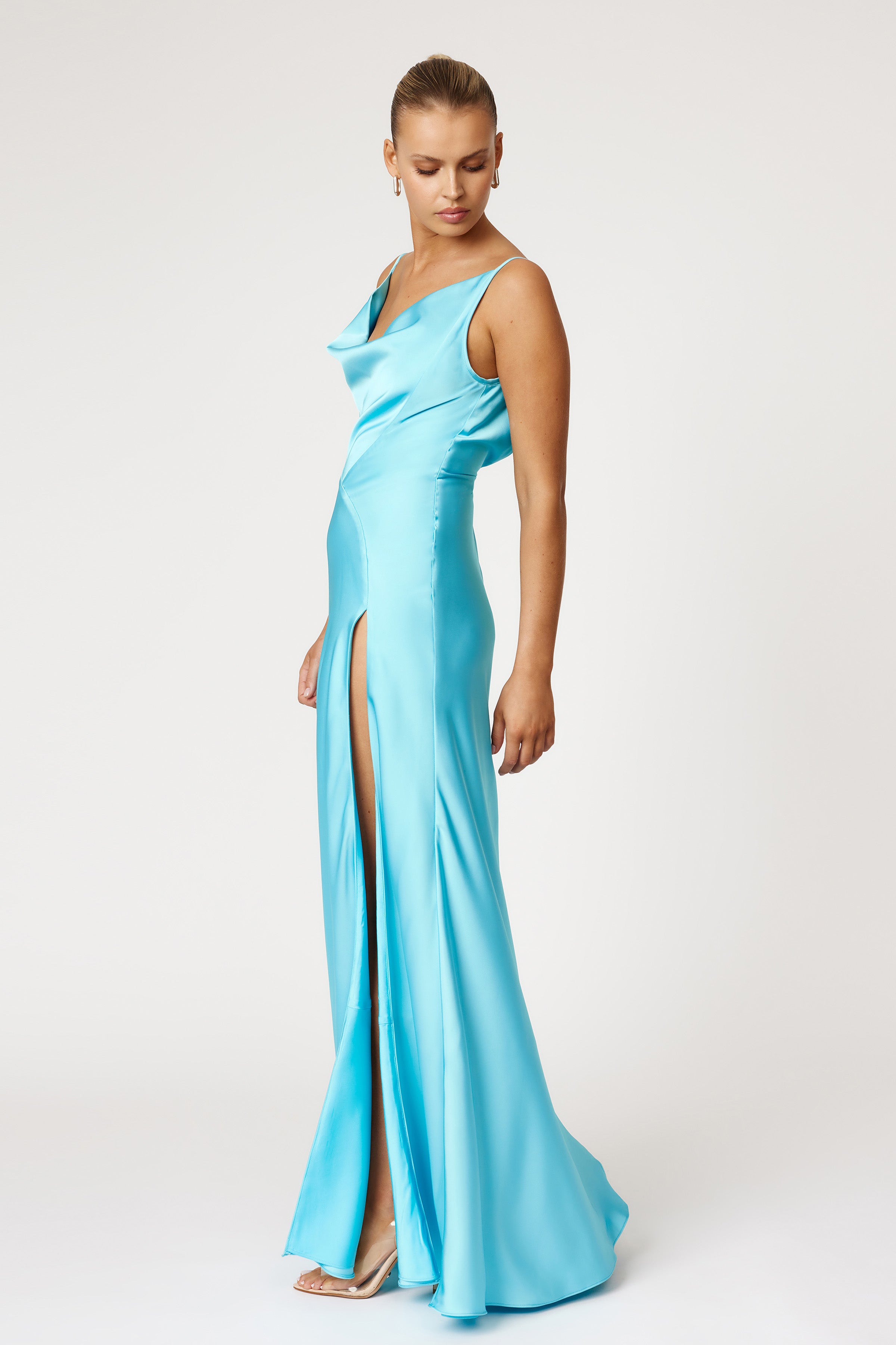 Monroe Dress featuring a silky fabric with a draped neckline and thigh-high split in vibrant lagoon blue by Studio Lexi