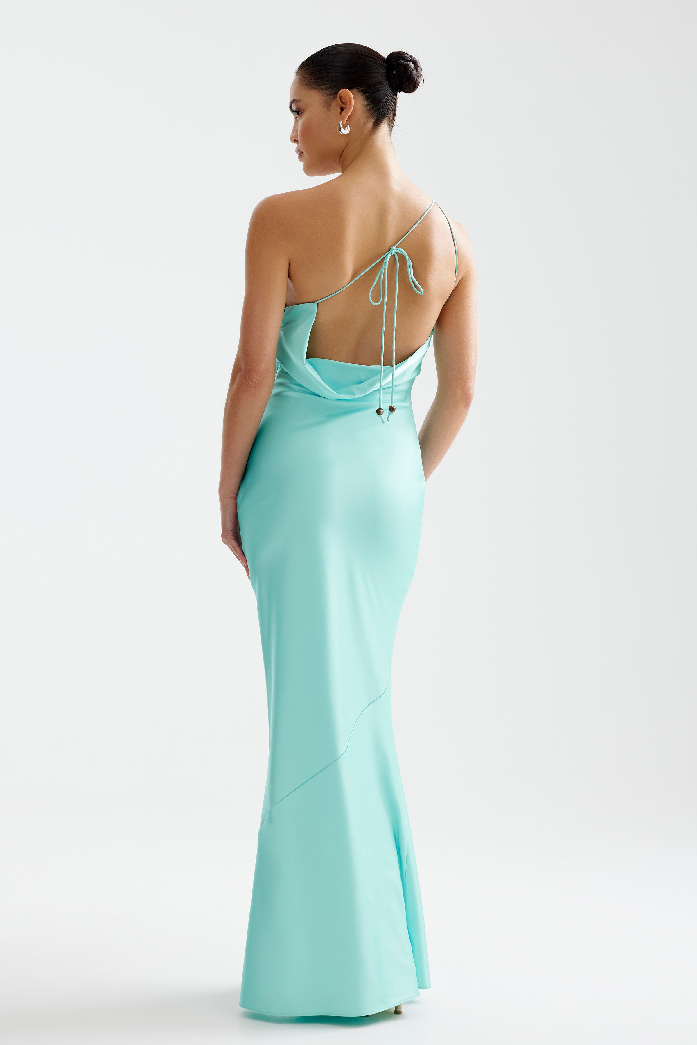 Nola Dress featuring a sleek backless design with thin straps and a flowing silhouette in aqua for formal wear