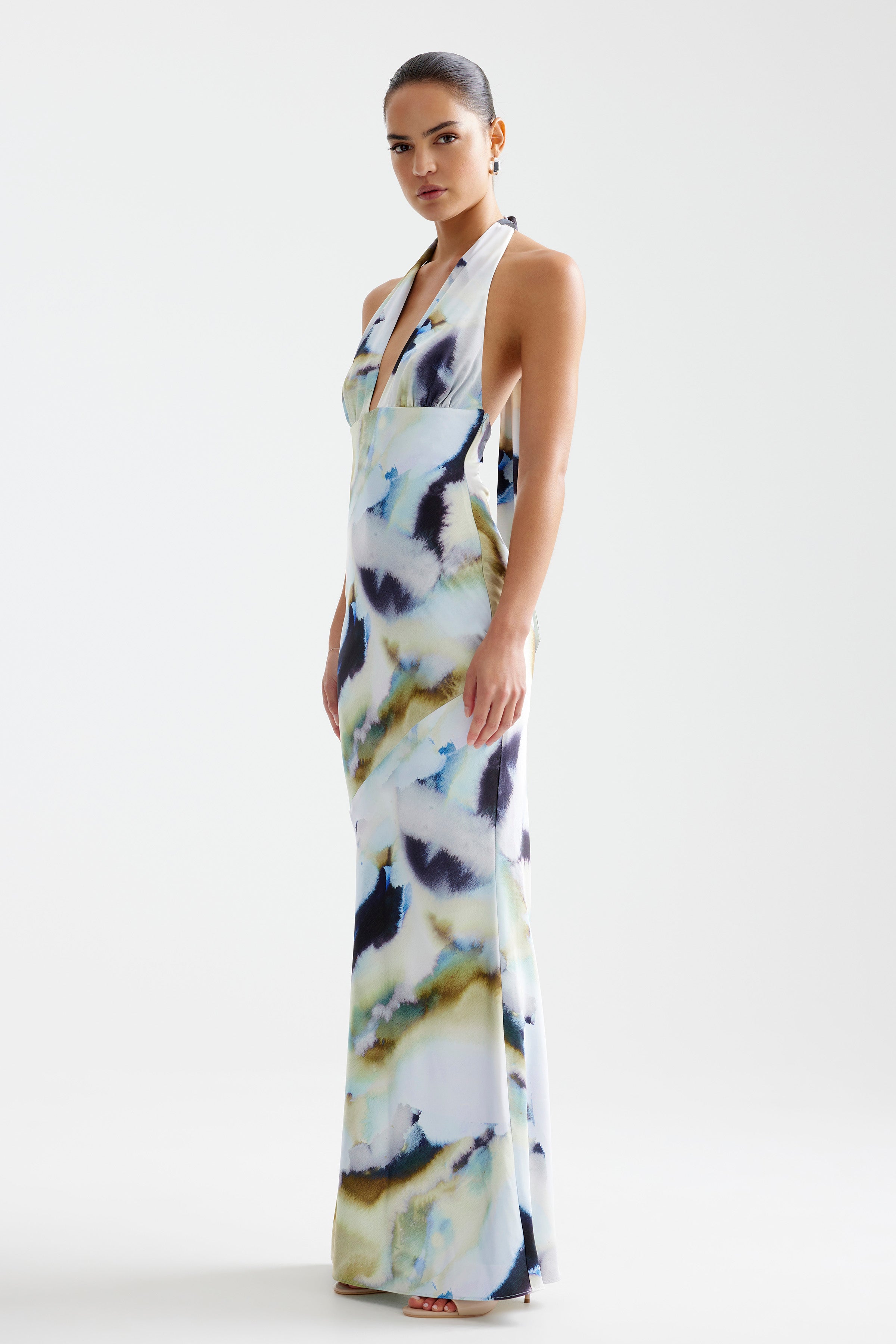Novia Dress featuring a halter neckline and backless silhouette in a flowing blue mineral print for formal occasions