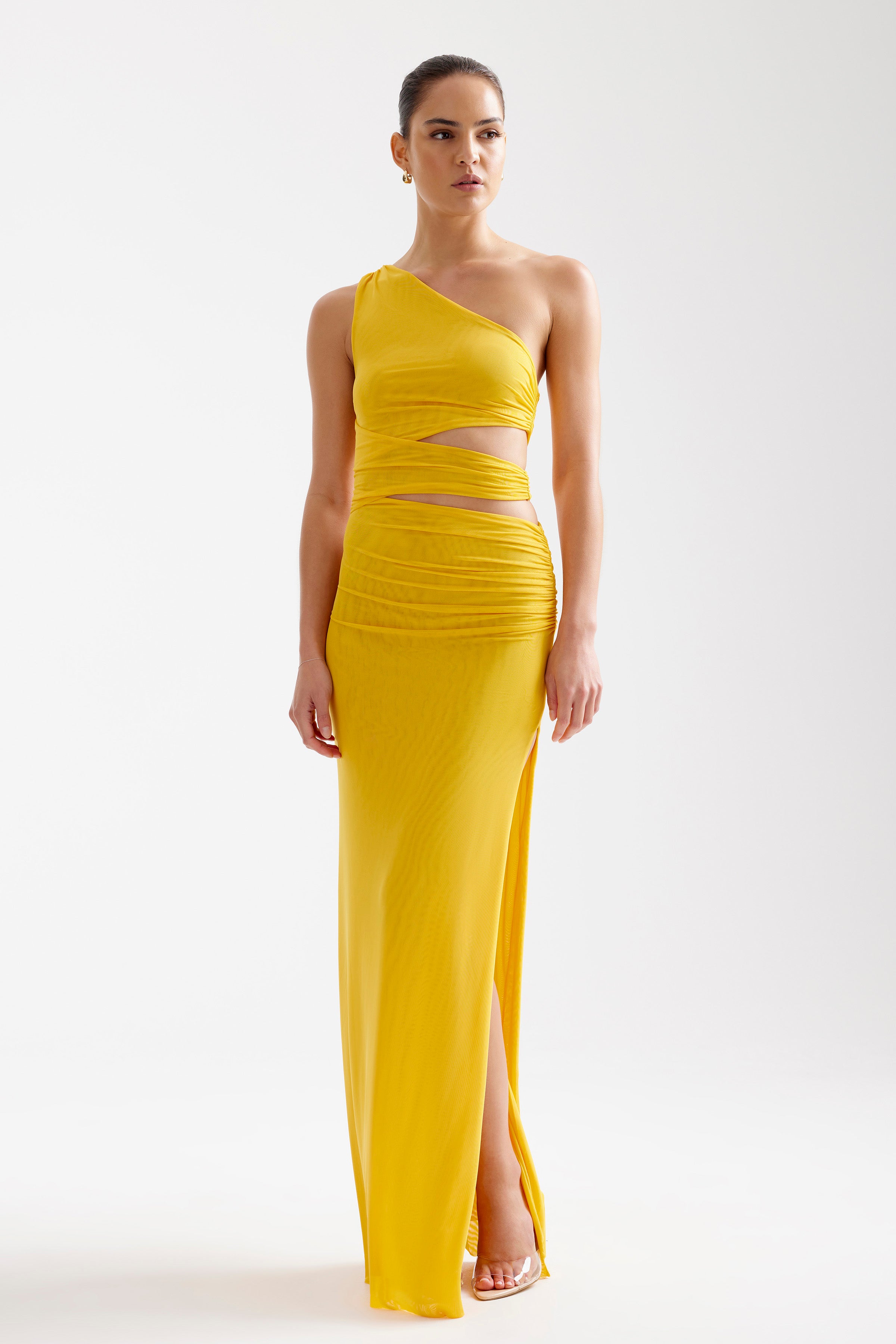 Nuri Dress featuring one-shoulder design with cutouts and split in vibrant yellow for formal and cocktail events