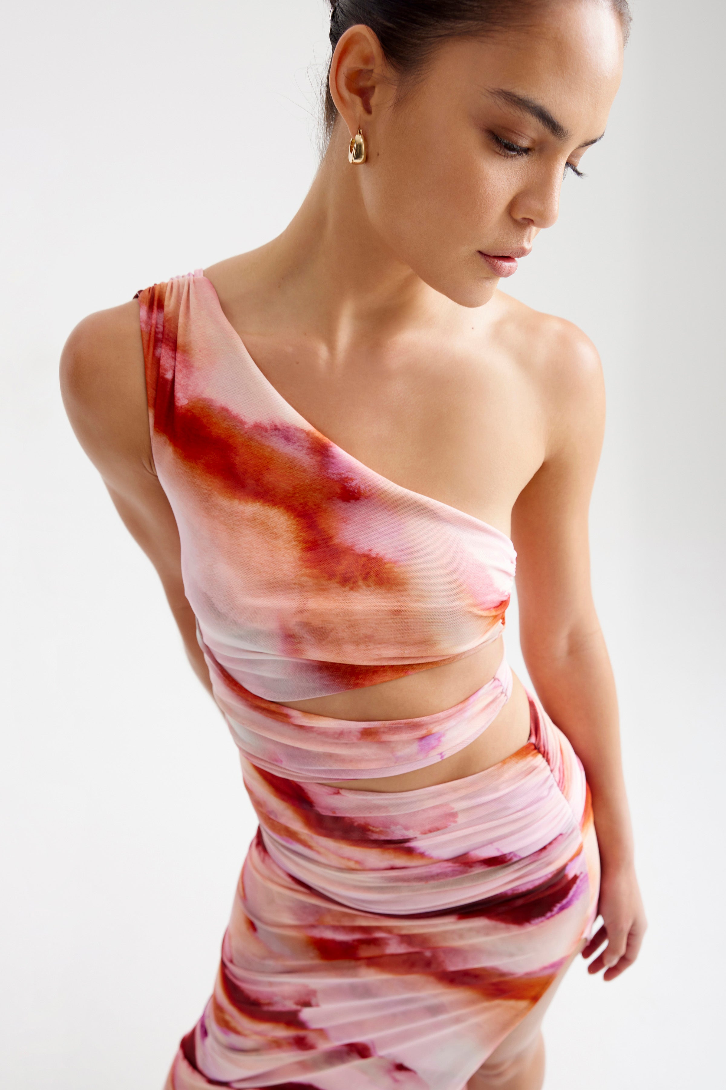Nuri Dress one-shoulder design with cutout details and ruched wrap in pink and orange mineral print by Studio Lexi
