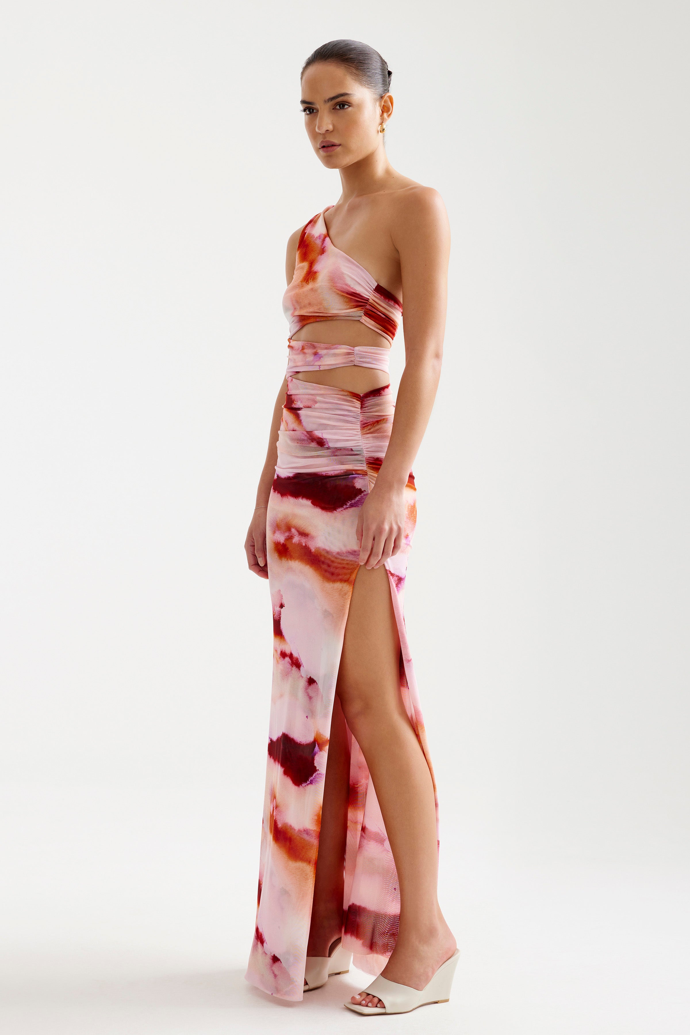 Nuri Dress with cutout details and thigh-high split in vibrant pink mineral print for elegant cocktail occasions by Studio Lexi