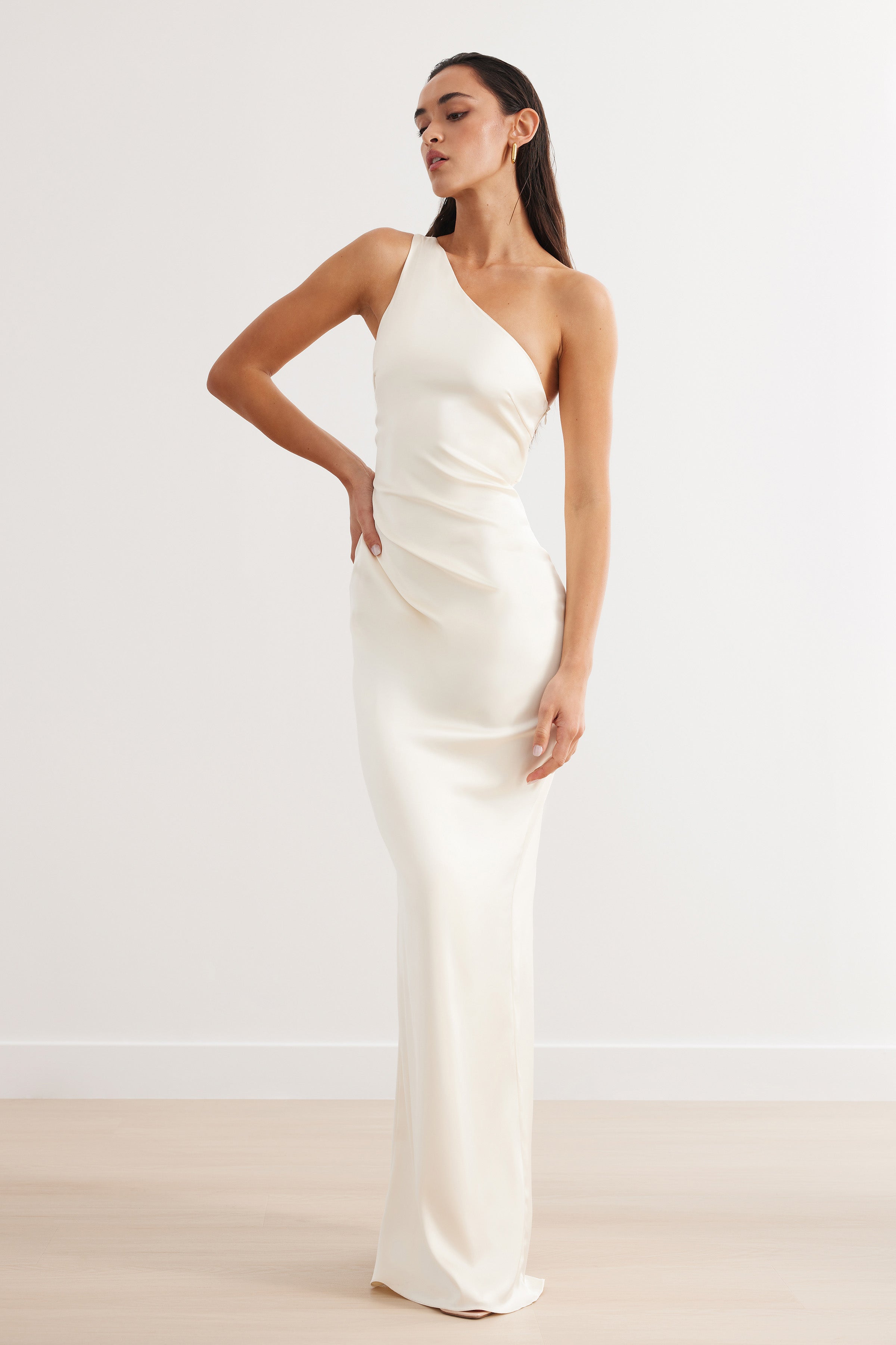 Oriana Dress featuring a cream one-shoulder silhouette with sleek long skirt for formal and black tie events