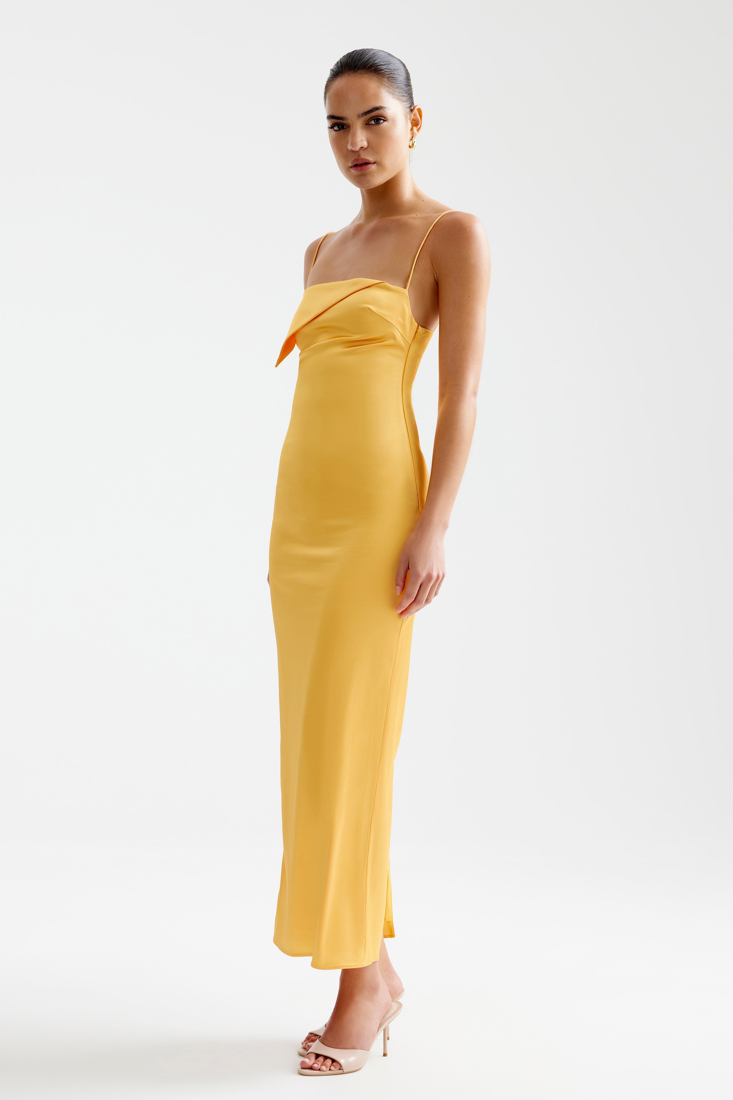 Rayna Dress featuring a sleek silhouette with thin straps and a modern folded neckline in papaya for formal events