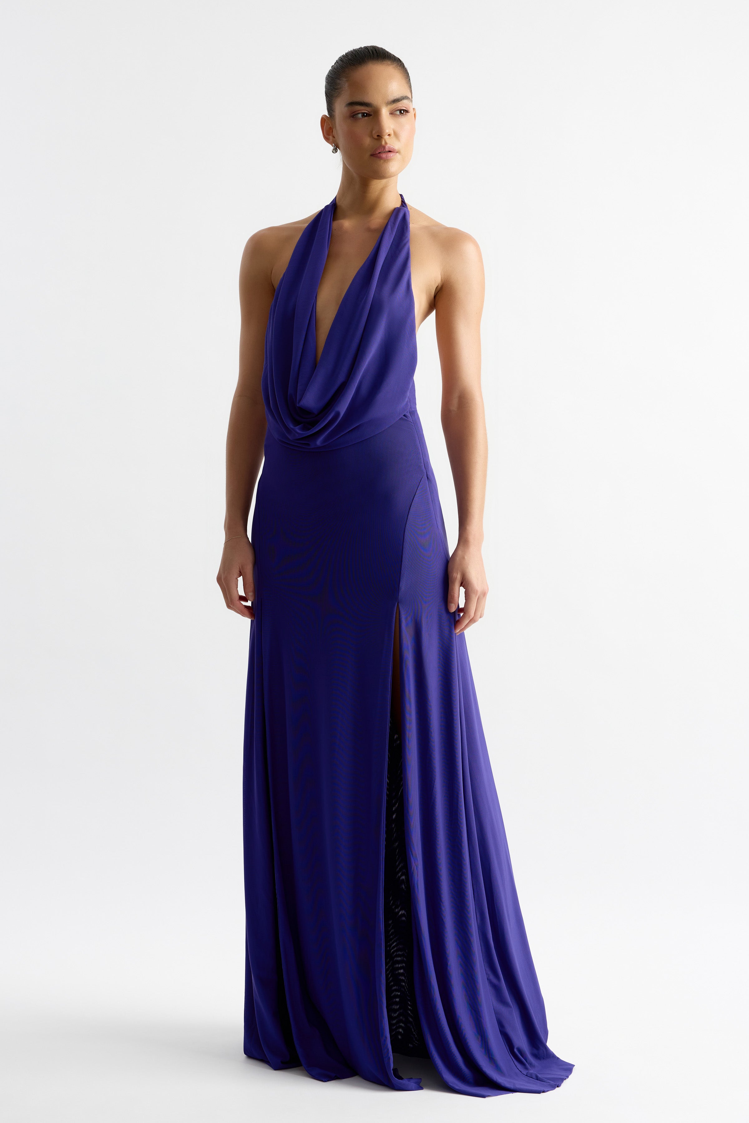 Savannah Dress - Indigo in portrait, featuring a low cowl neckline, halter tie, and flowing A-line skirt with twin splits.