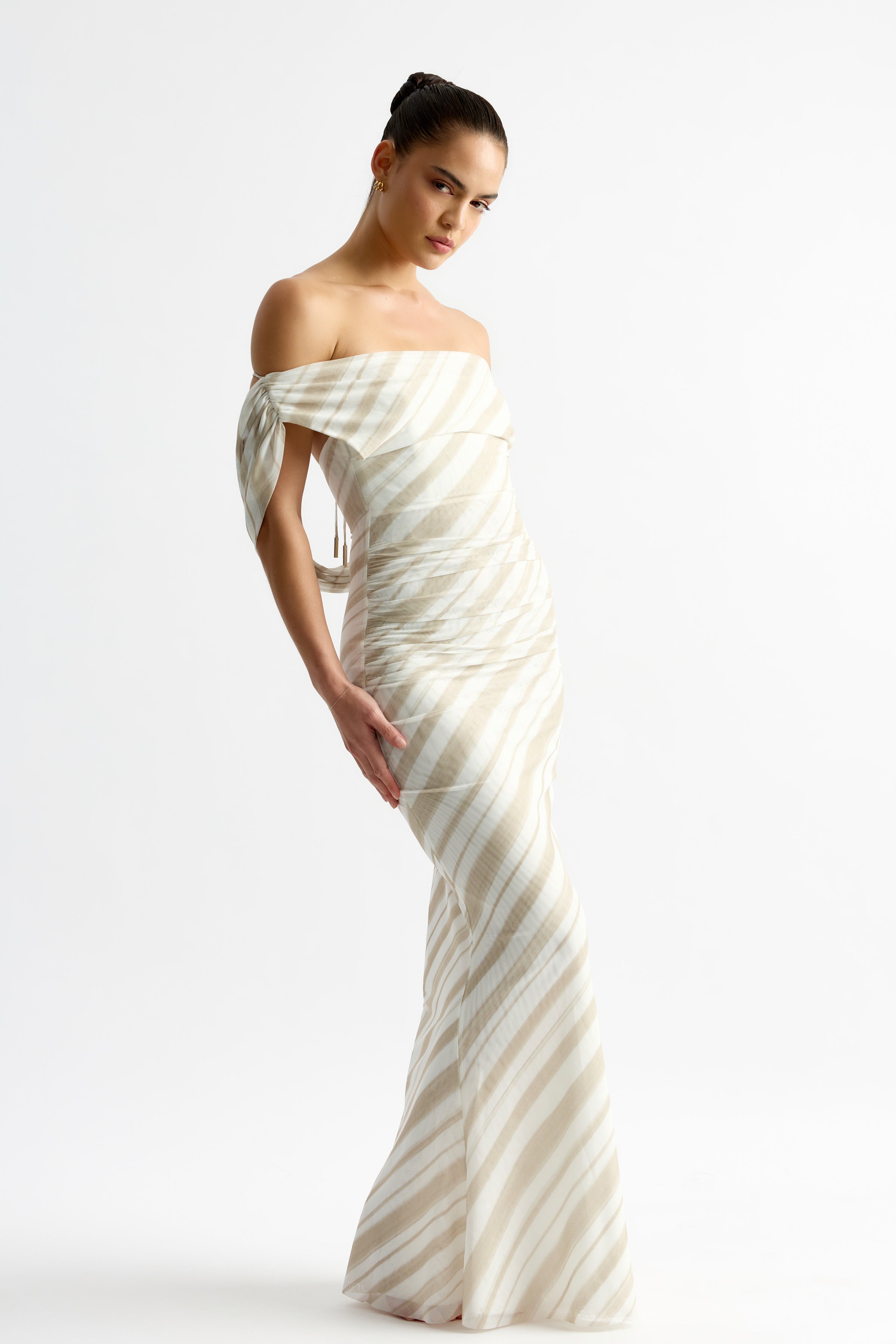 Sebastian Dress featuring a fitted off-shoulder silhouette with draped sleeves in beige stripe print by Studio Lexi for formal occasions