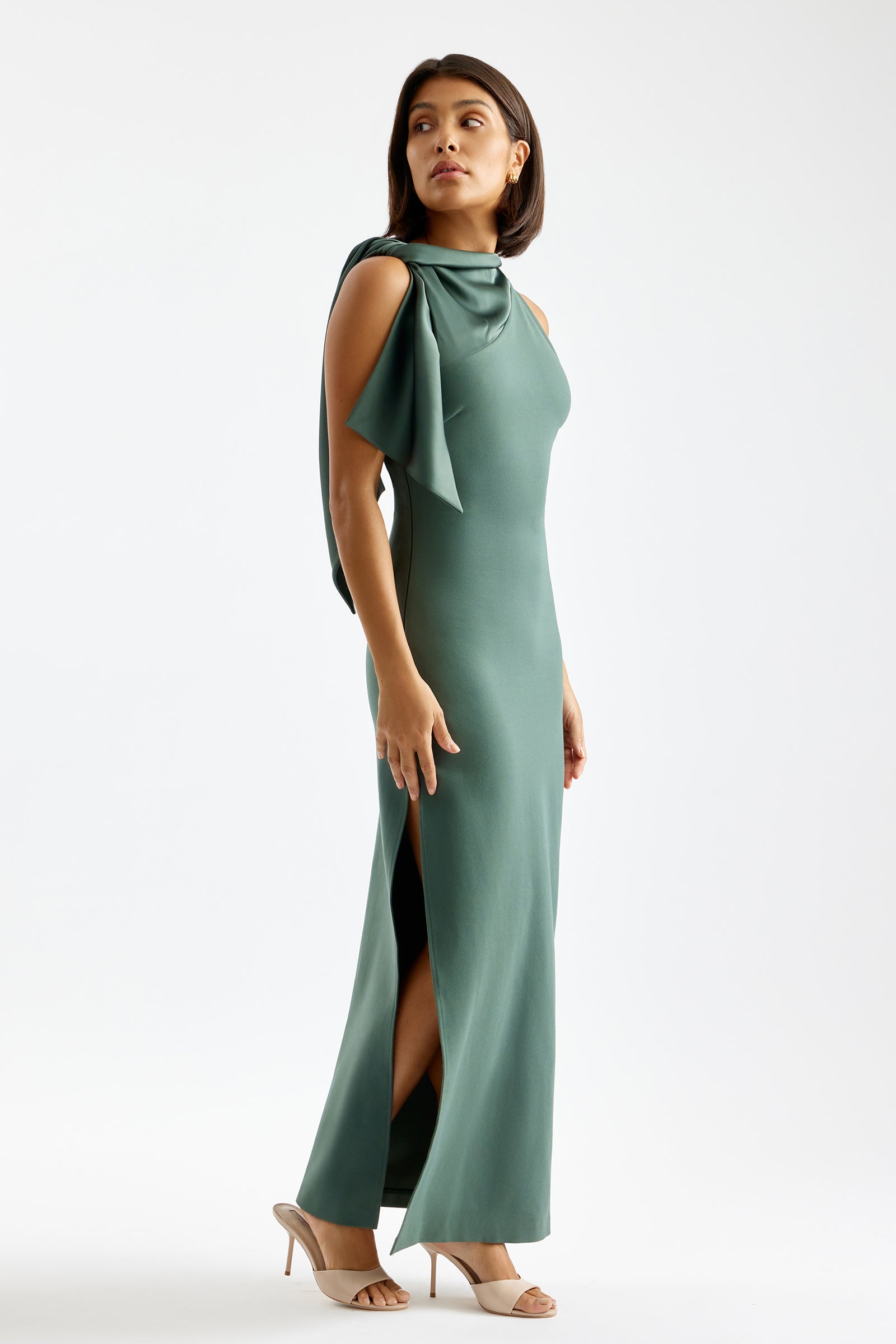 Shilo Dress sleeveless fitted design with sculpted neckline, side split, and shoulder bow detail in army green by Studio Lexi