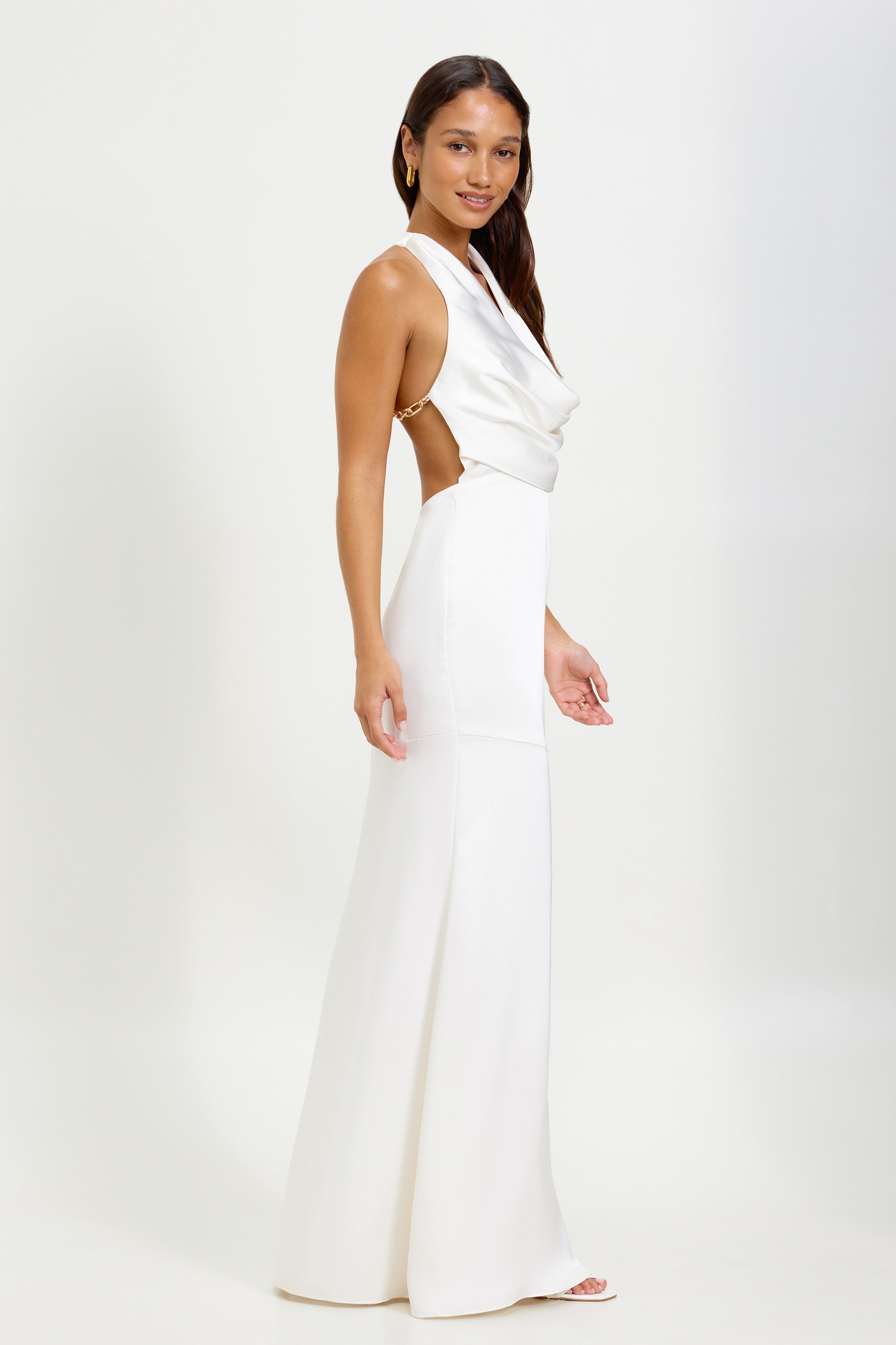 Silvana Dress featuring a draped halter neckline with backless chain detail in soft oyster for formal events