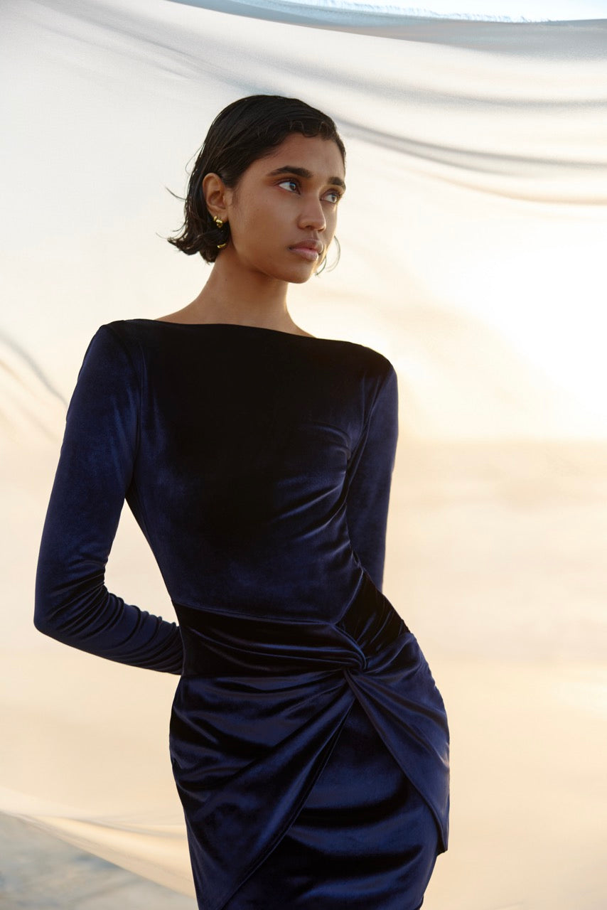 Stevie Dress featuring a sleek long sleeve silhouette with gathered detail in midnight blue velvet by Studio Lexi