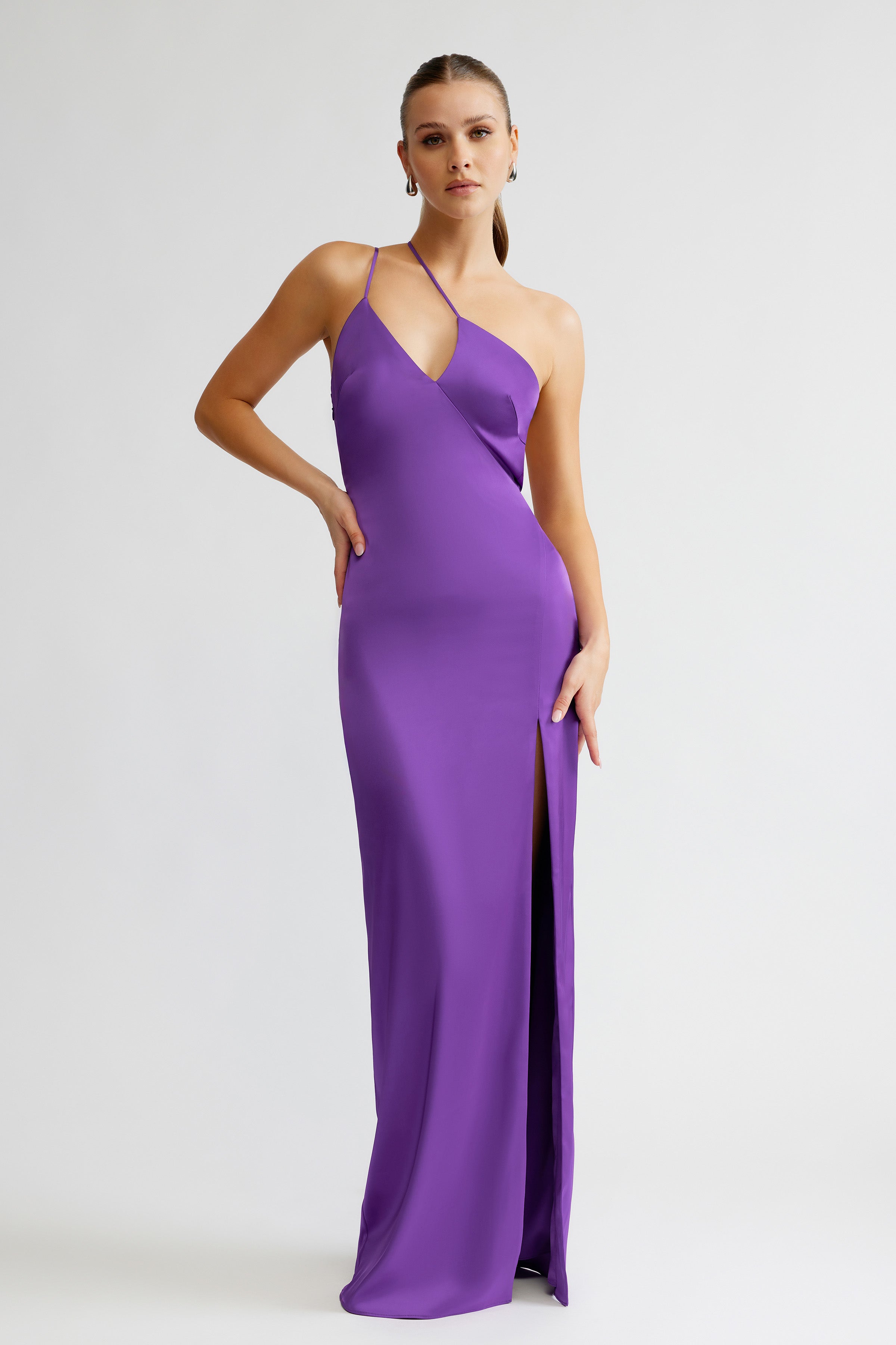 Thalia Dress featuring a sleek silhouette with asymmetric neckline and thigh-high split in violet satin for formal occasions