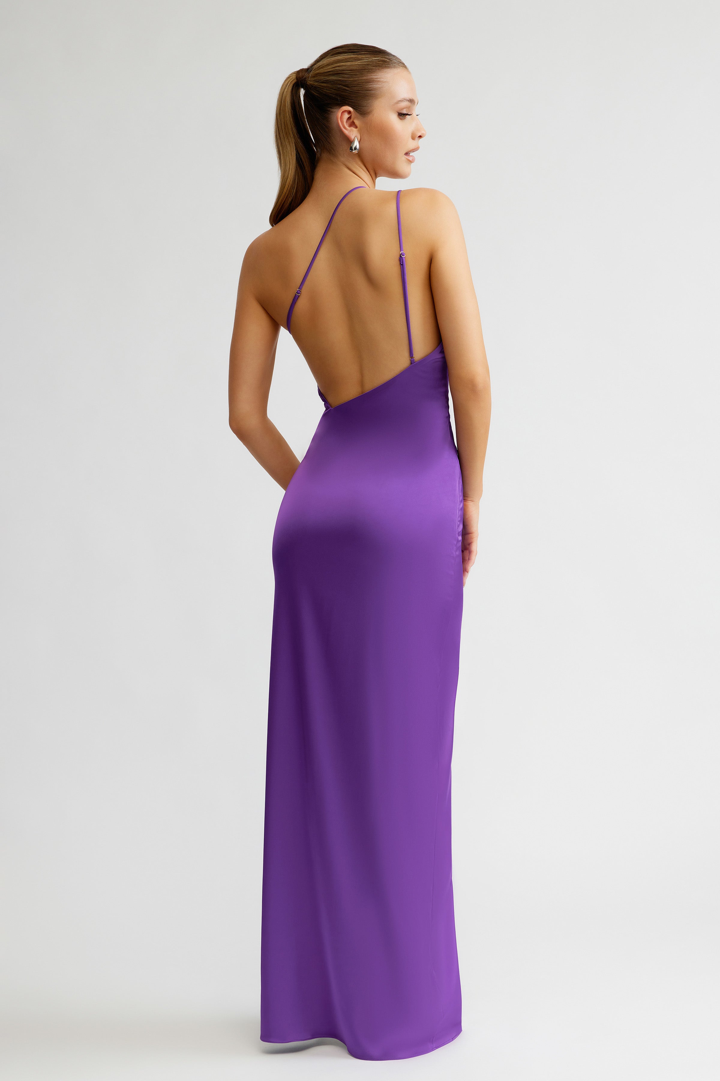Thalia Dress featuring a sleek backless design with delicate straps in violet satin for formal and black tie occasions