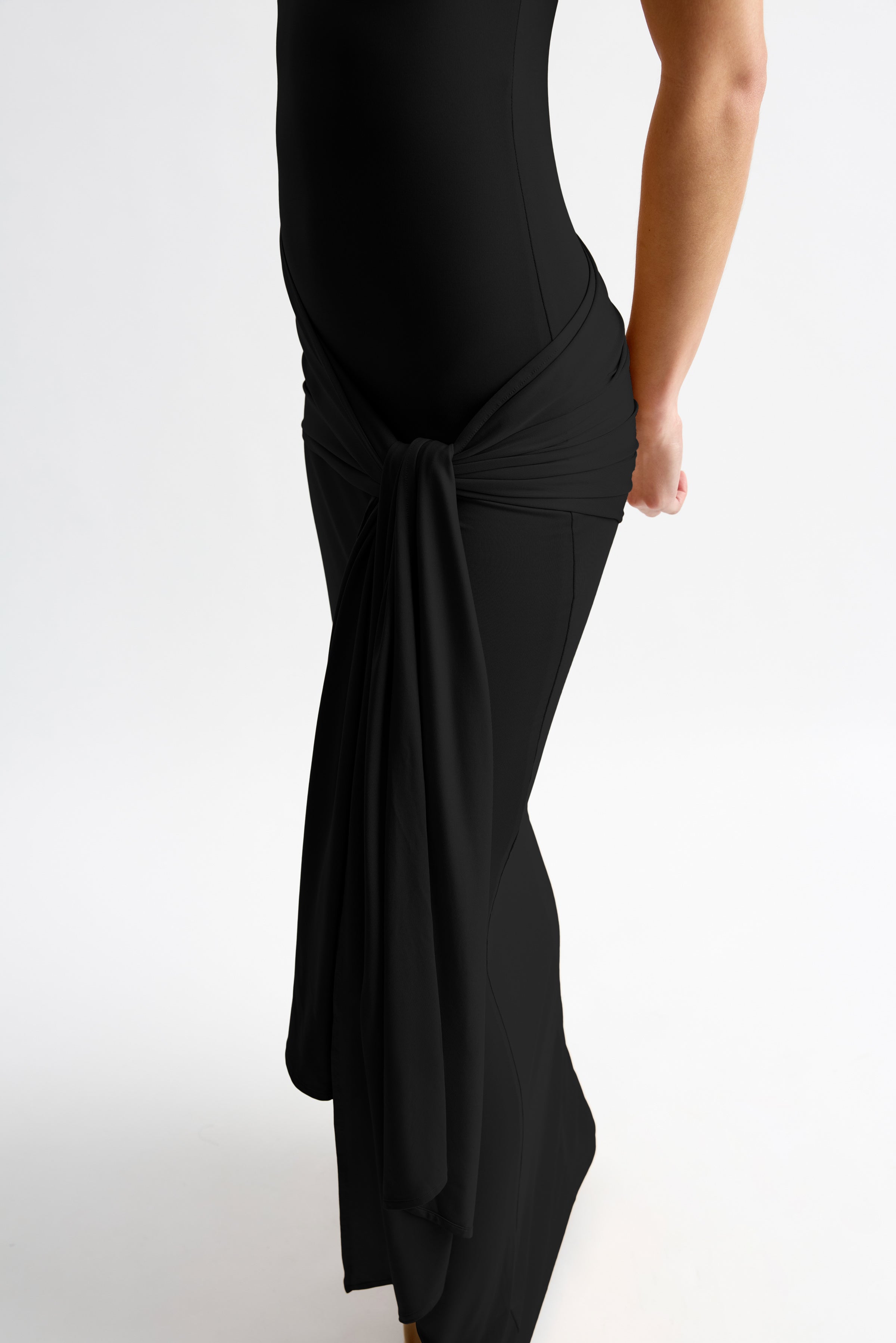 Thierry Dress featuring a sleek fitted silhouette with a side drape detail in black by Studio Lexi for formal wear