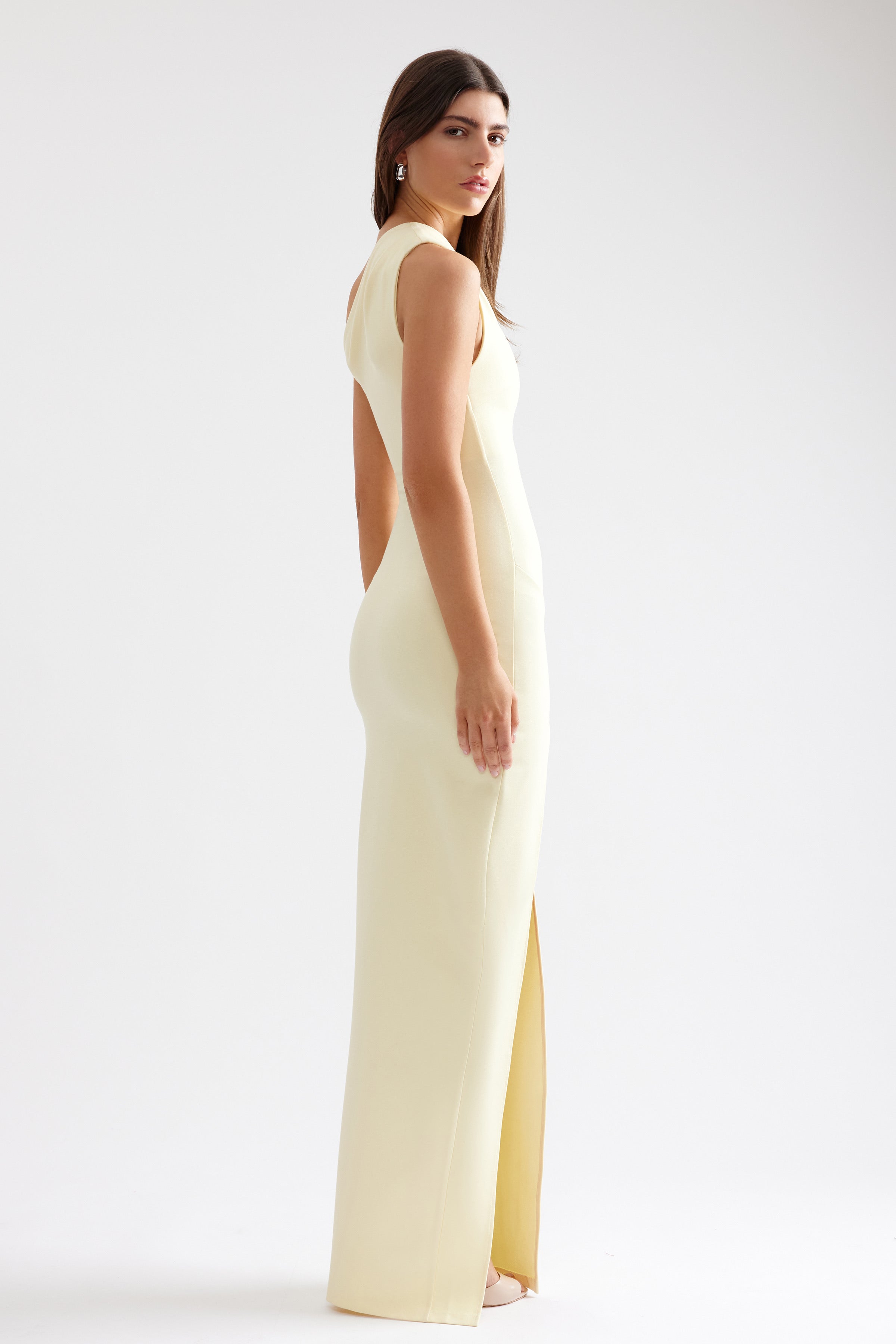 Yolanda Dress featuring a firm fit with a sleek silhouette and split detail in lemon for formal and wedding guest occasions