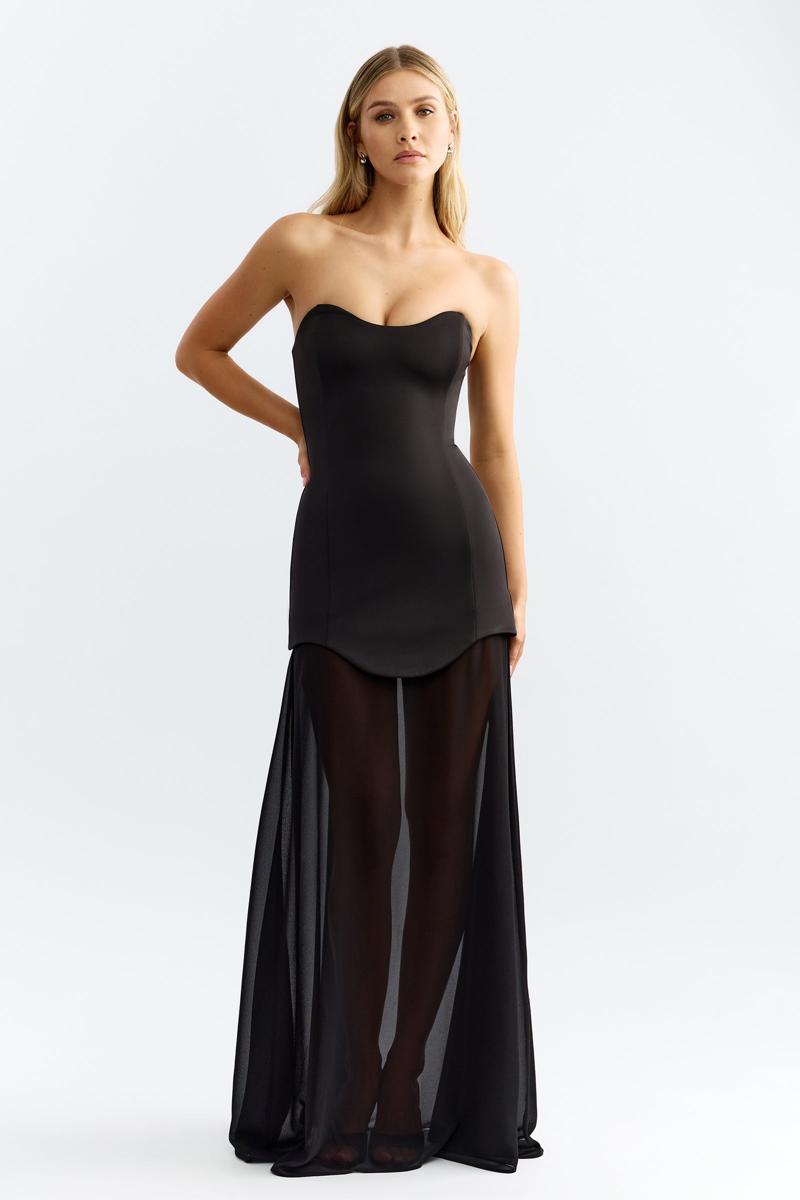 Zahra Dress featuring a strapless sweetheart neckline and fitted bodice with sheer flowing black skirt for formal occasions