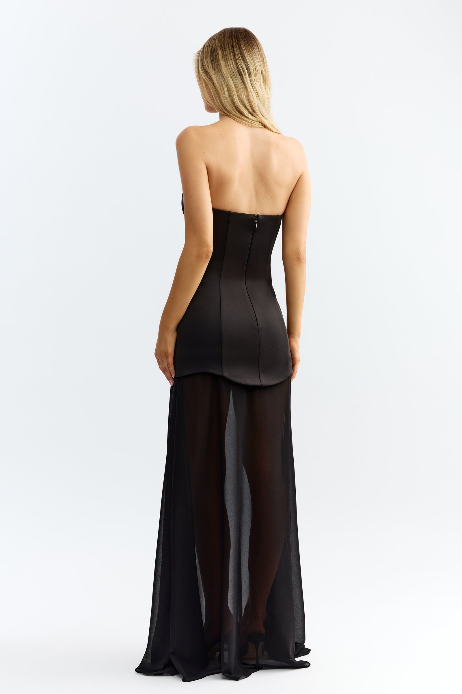 Zahra Dress featuring strapless backless design with fitted bodice and sheer flowing skirt in black for formal occasions by Studio Lexi