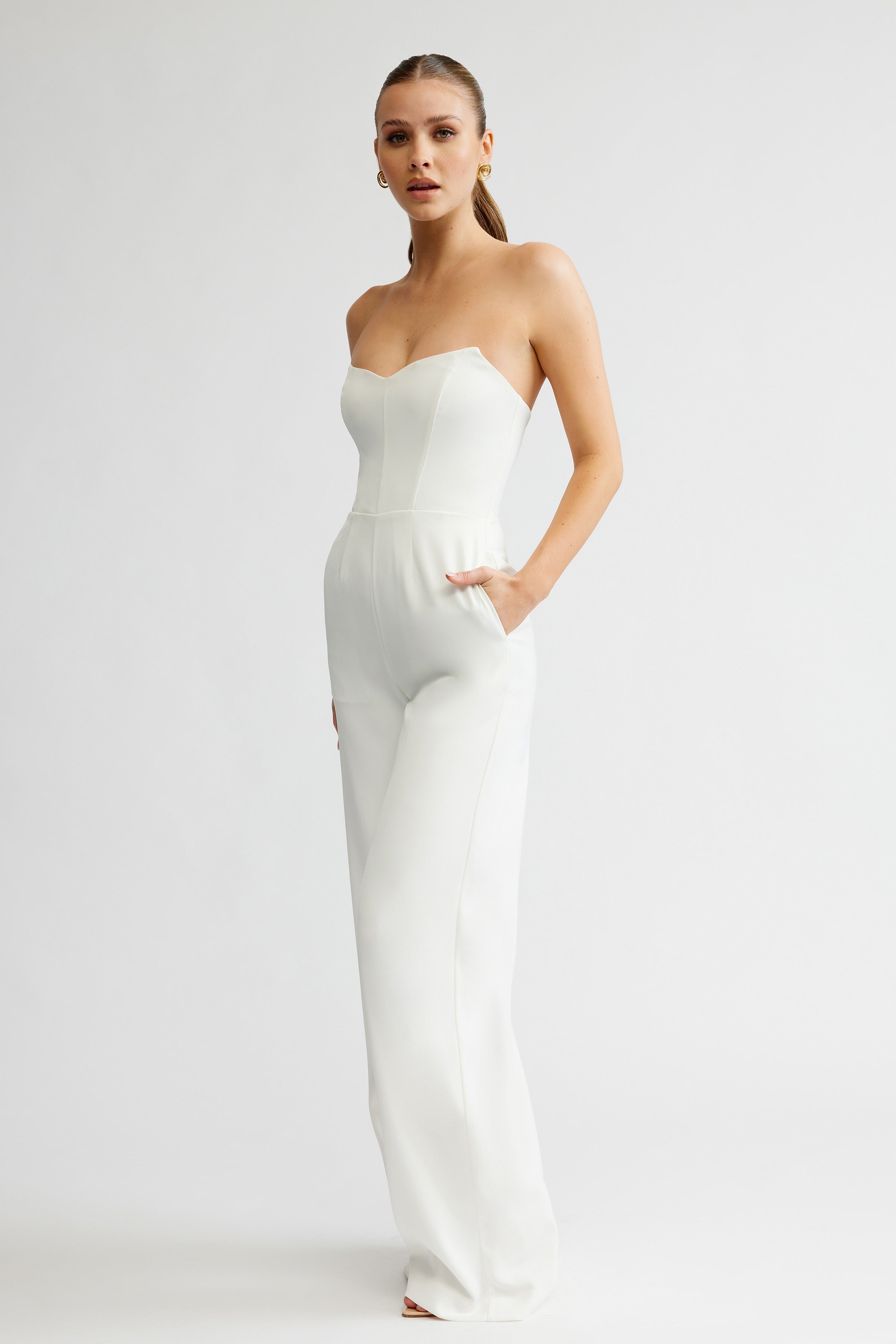 Zale Jumpsuit featuring a strapless, fitted bodice and tailored wide-leg pants in elegant white satin fabric