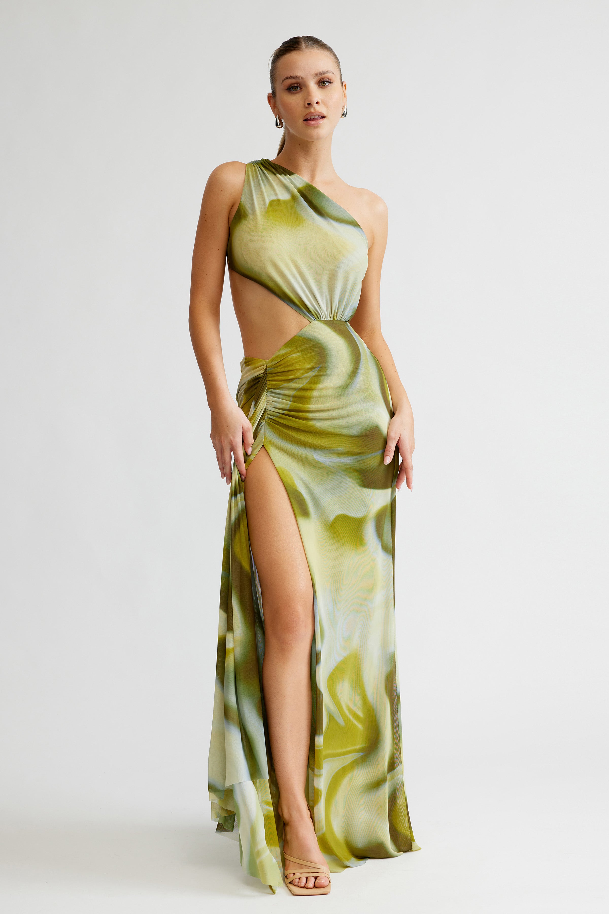 Zaniah Dress featuring an asymmetric cutout design with high leg split in sage liquify print for formal wear
