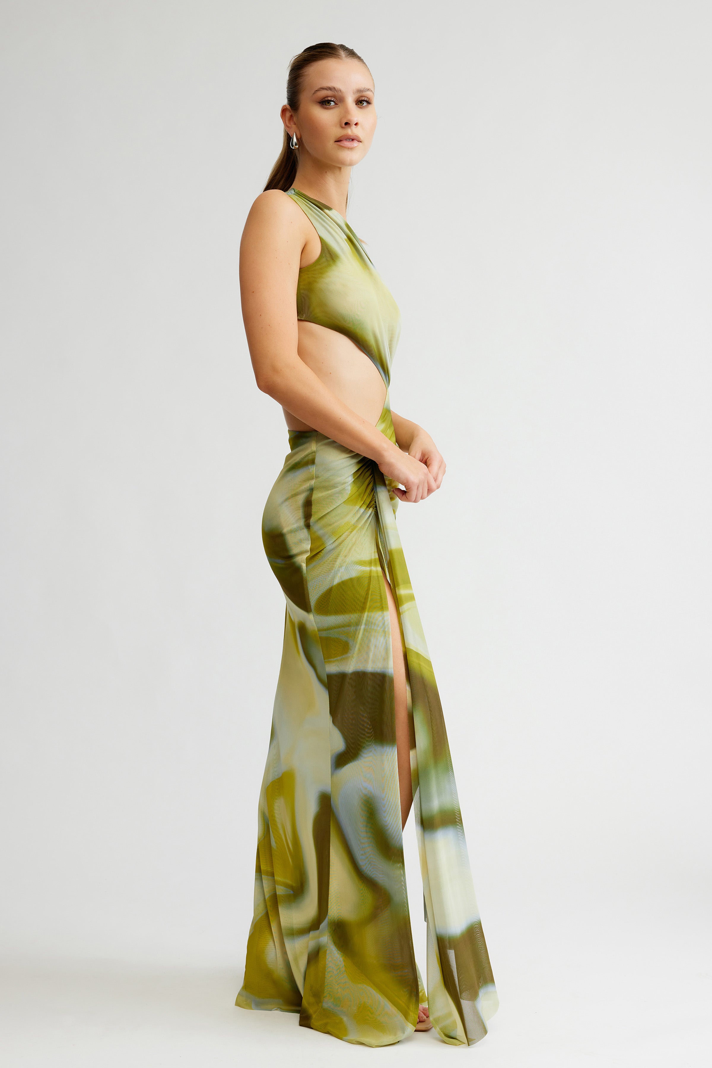 Zaniah Dress featuring a side cutout with high slit and sleeveless design in sage liquify print for formal events
