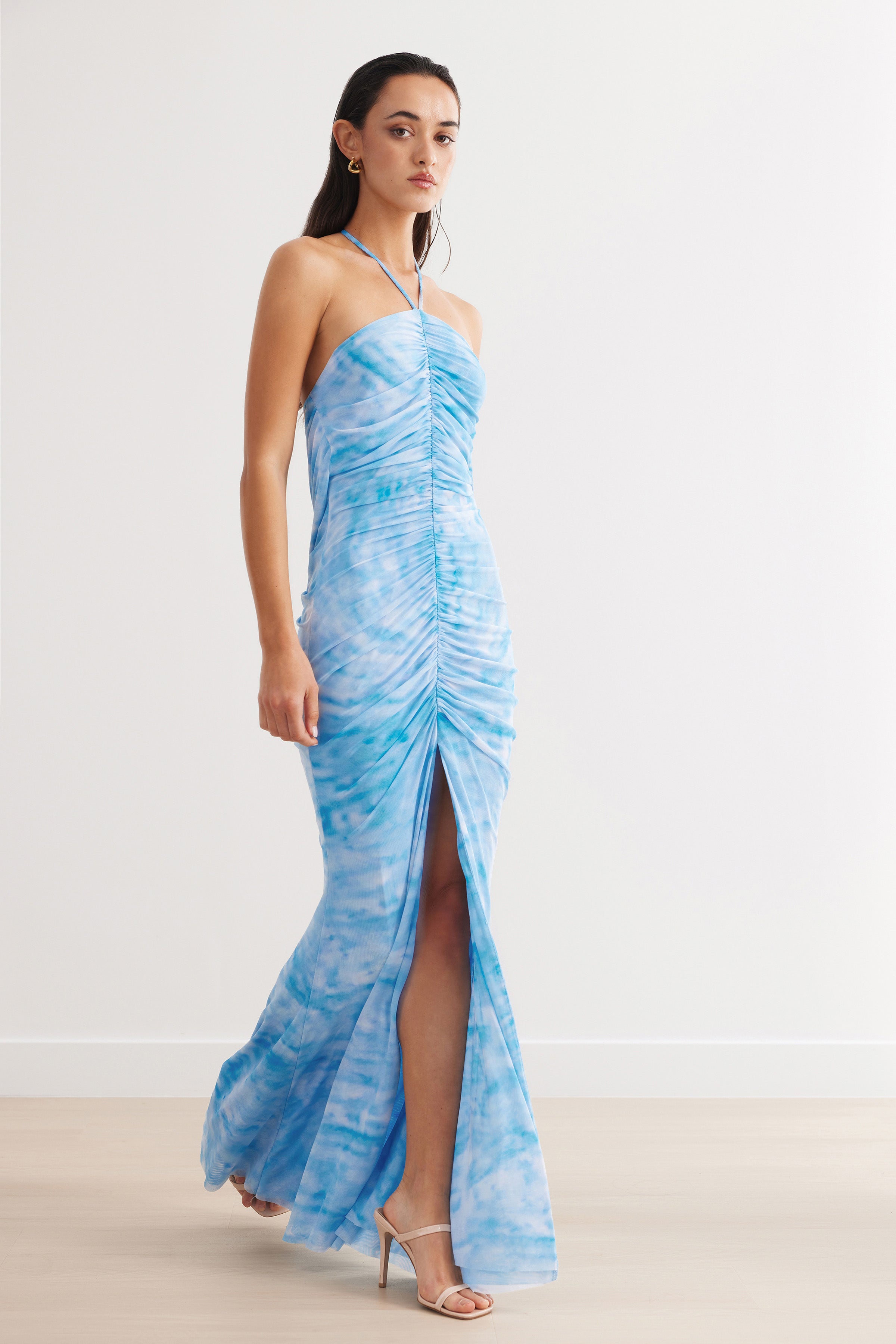 Amber Dress featuring ruched front and halter neck in blue print with split hem for formal and wedding guest occasions