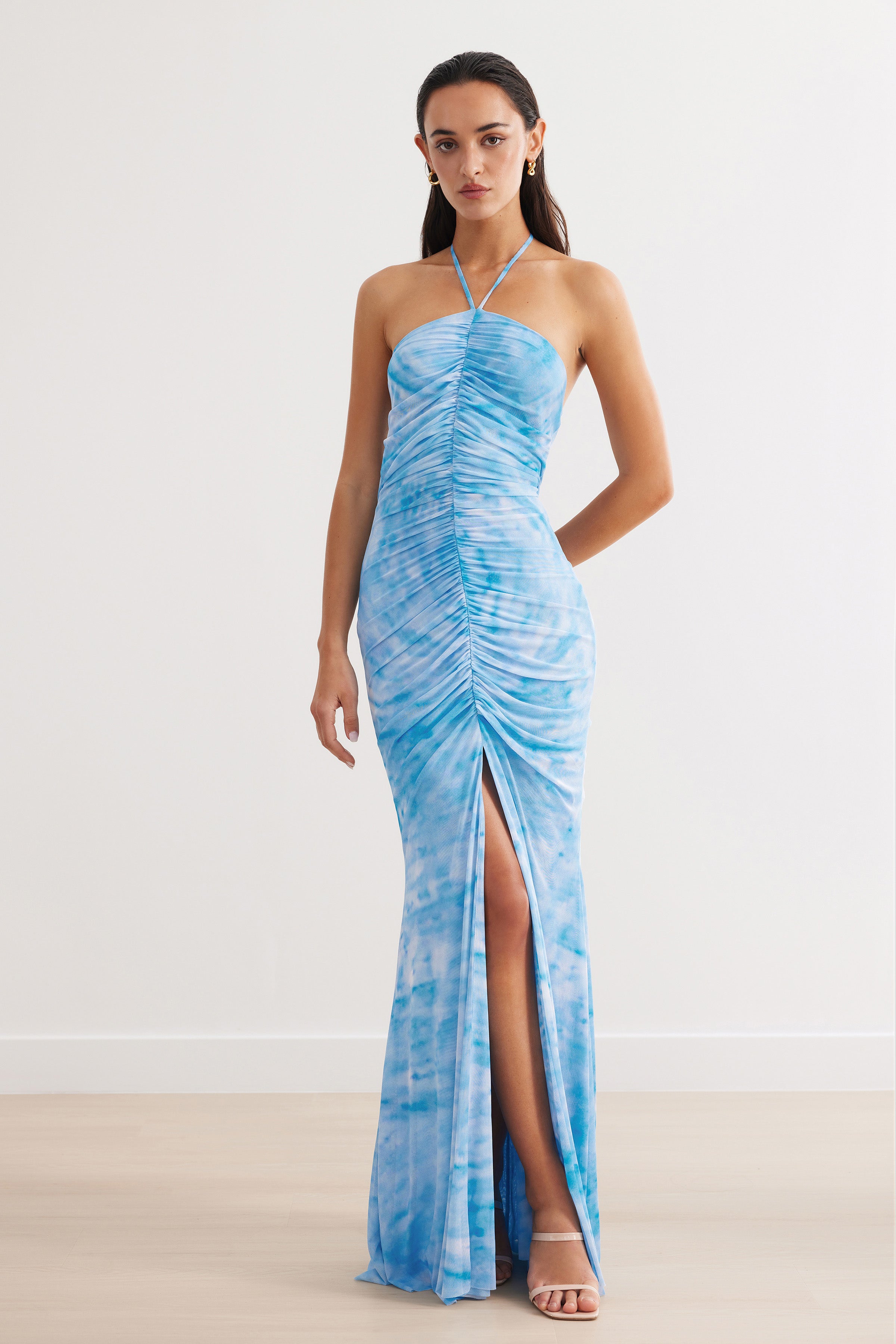 Amber Dress featuring a ruched design with halter strap and front split in blue print for formal and wedding guest occasions