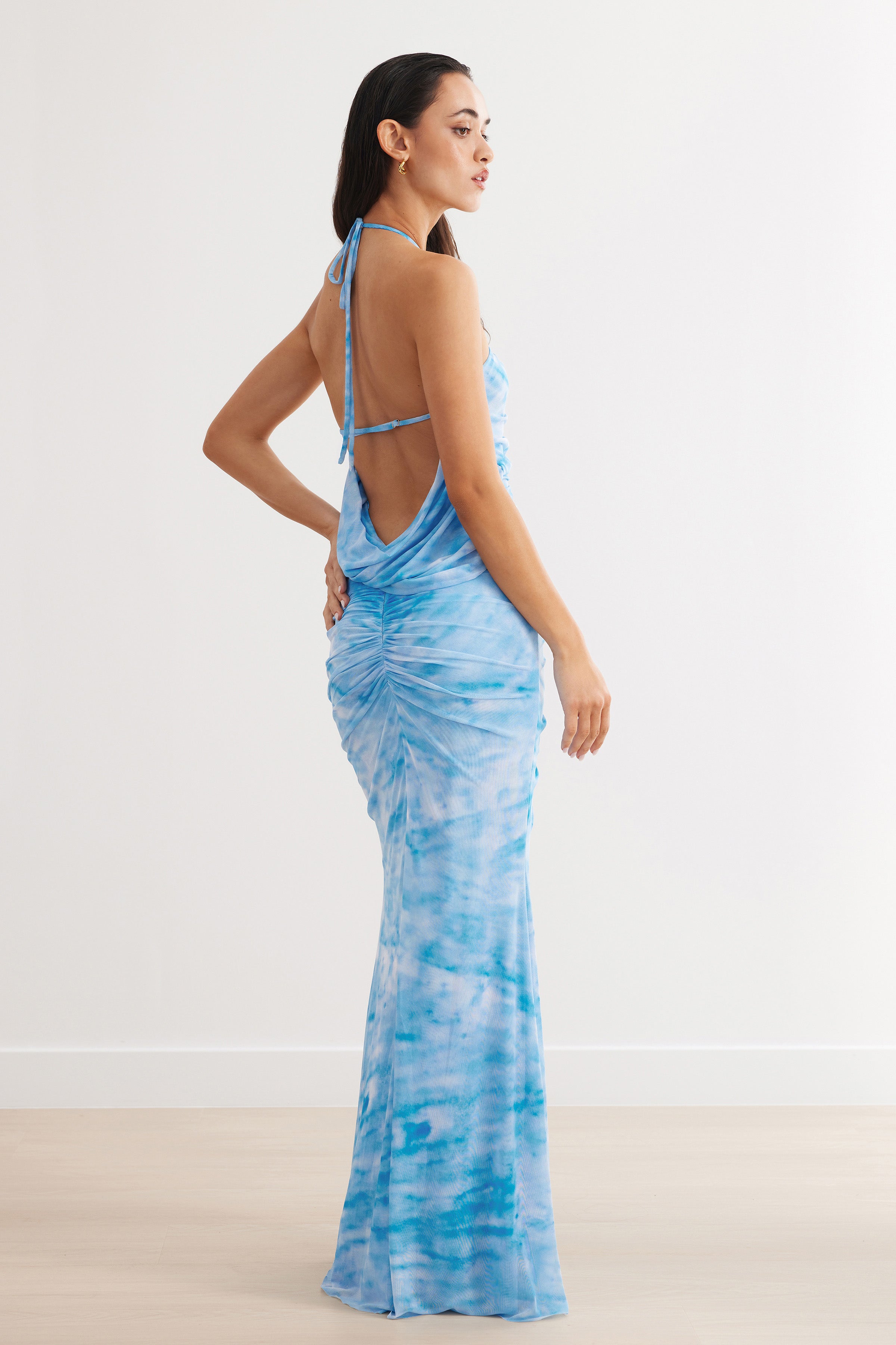 Amber Dress featuring a backless, ruched design with split hem in blue print for formal and wedding guest occasions