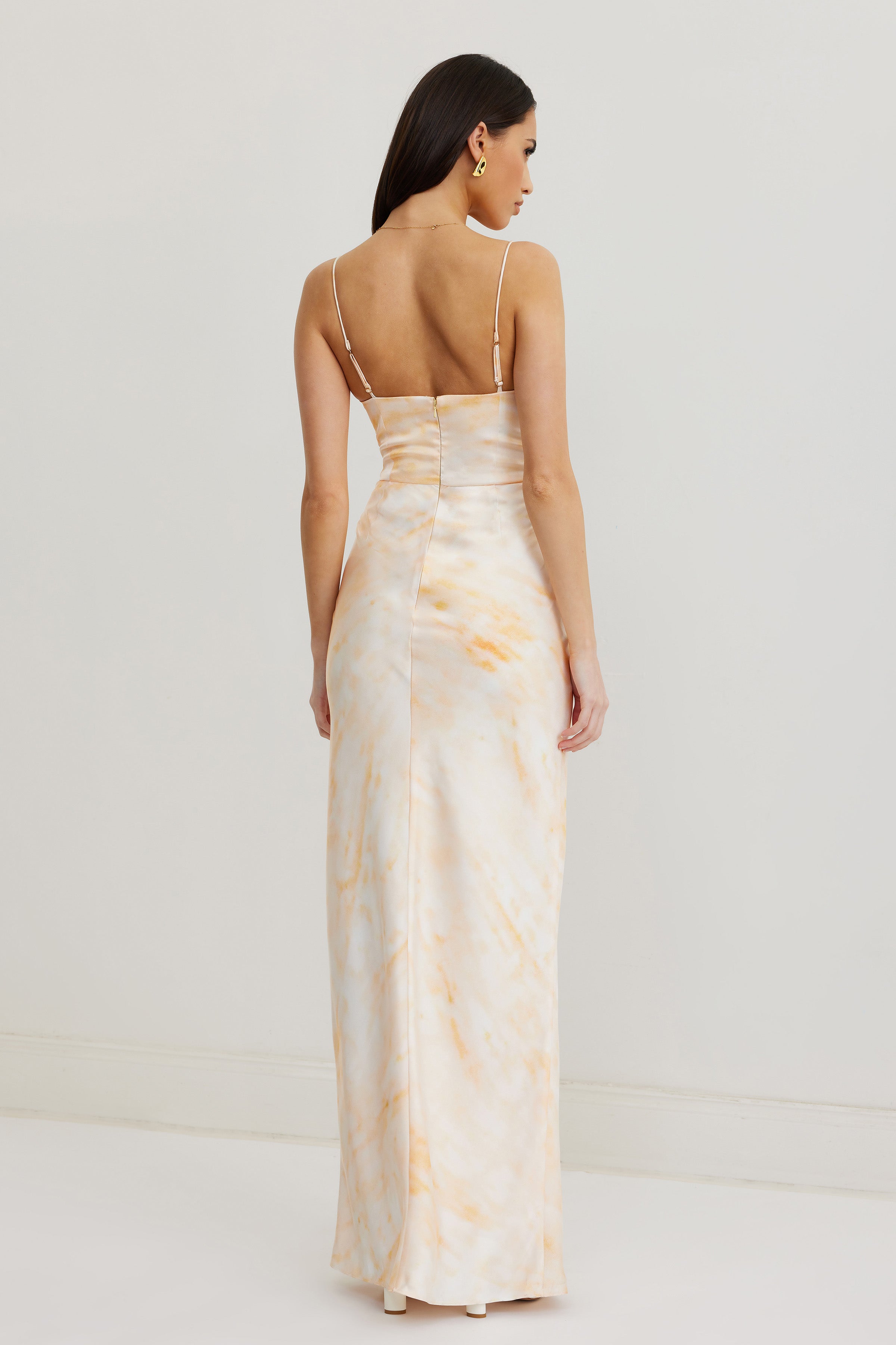 Arizona Dress featuring a backless design with thin adjustable straps and a soft orange print for formal wear