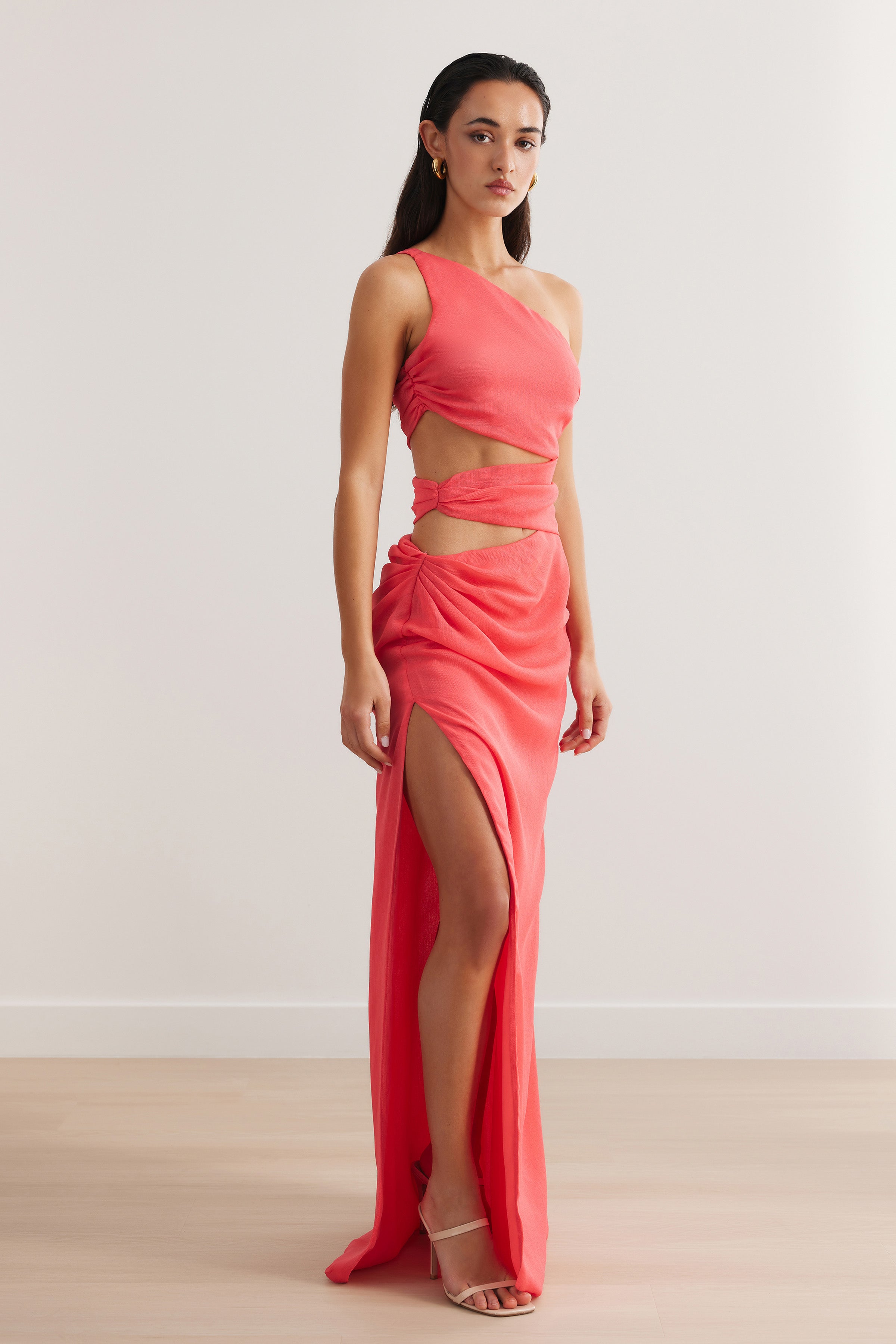 Aurea Dress with cutout waist, one-shoulder design, and high slit in vibrant flamingo pink for formal occasions