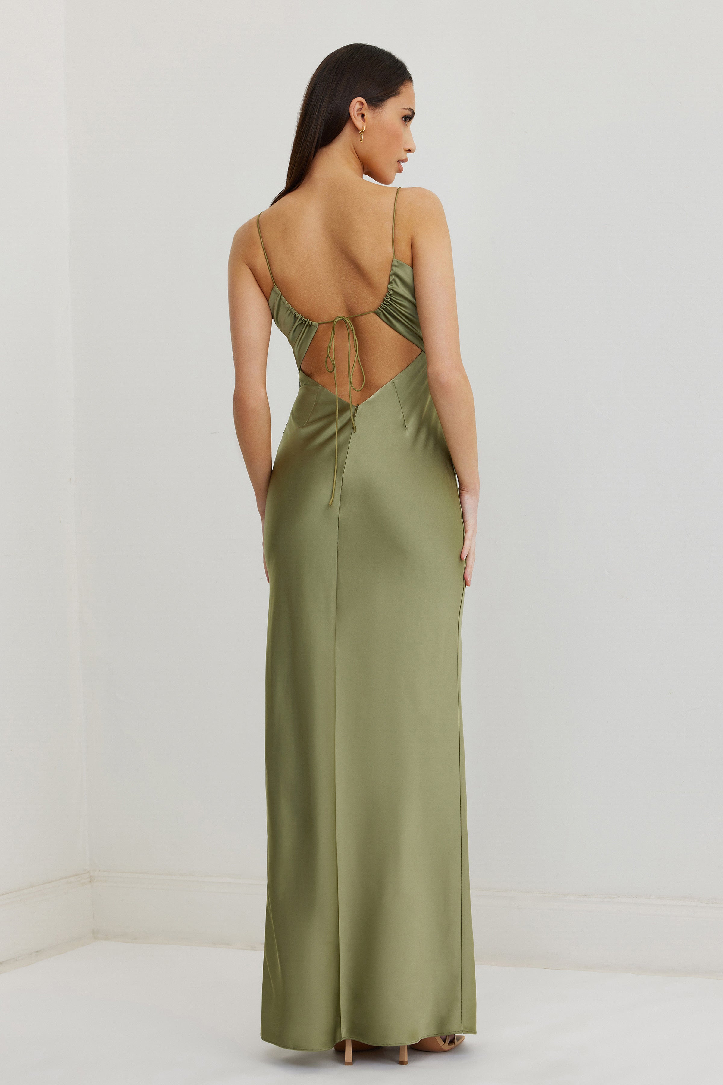 Dakota Dress featuring an open back with tie detail and a smooth moss green satin finish for formal occasions