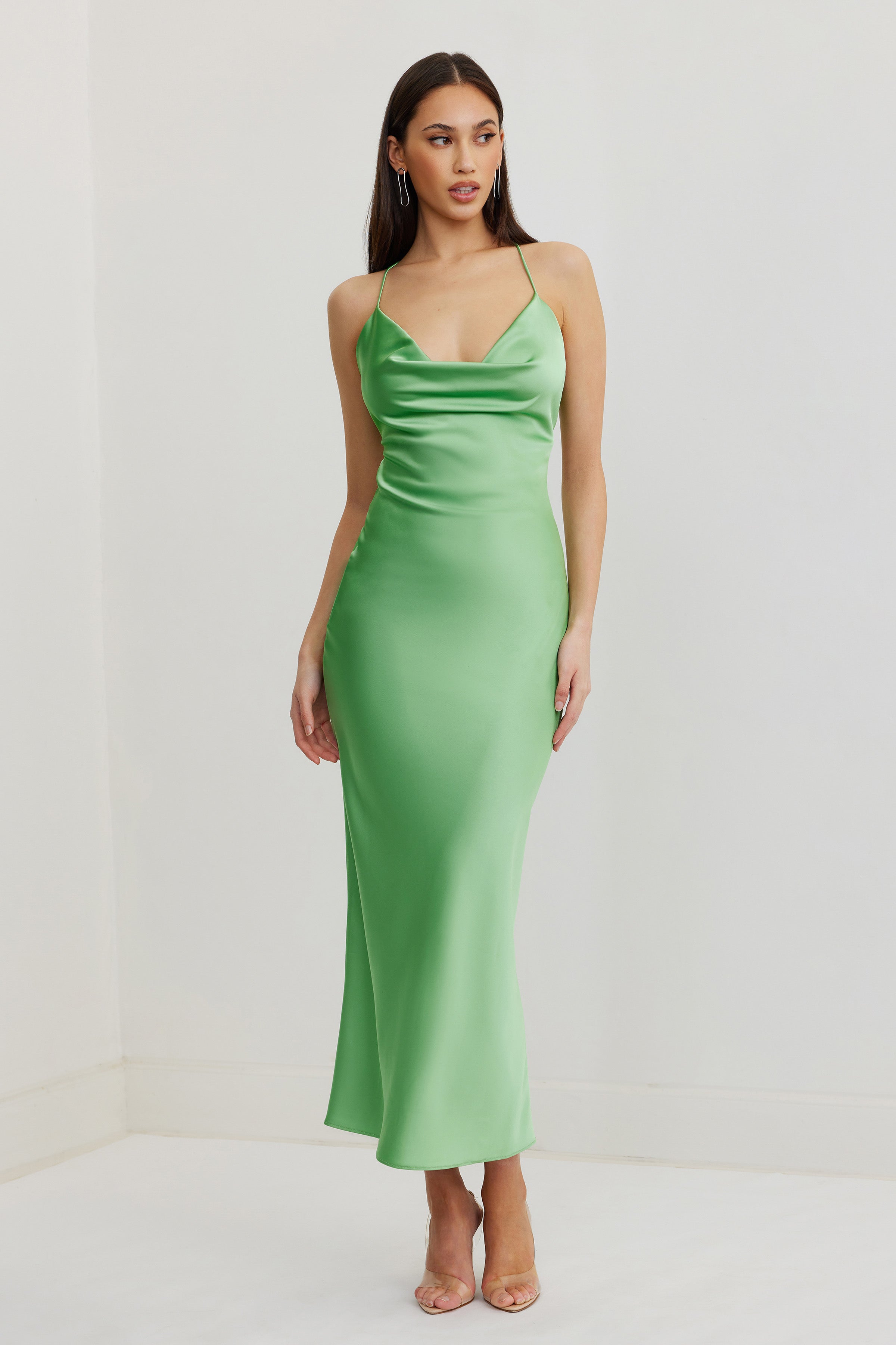 Dove Dress featuring a sleek satin finish, draped neckline, and slim straps in vibrant kiwi green for formal occasions