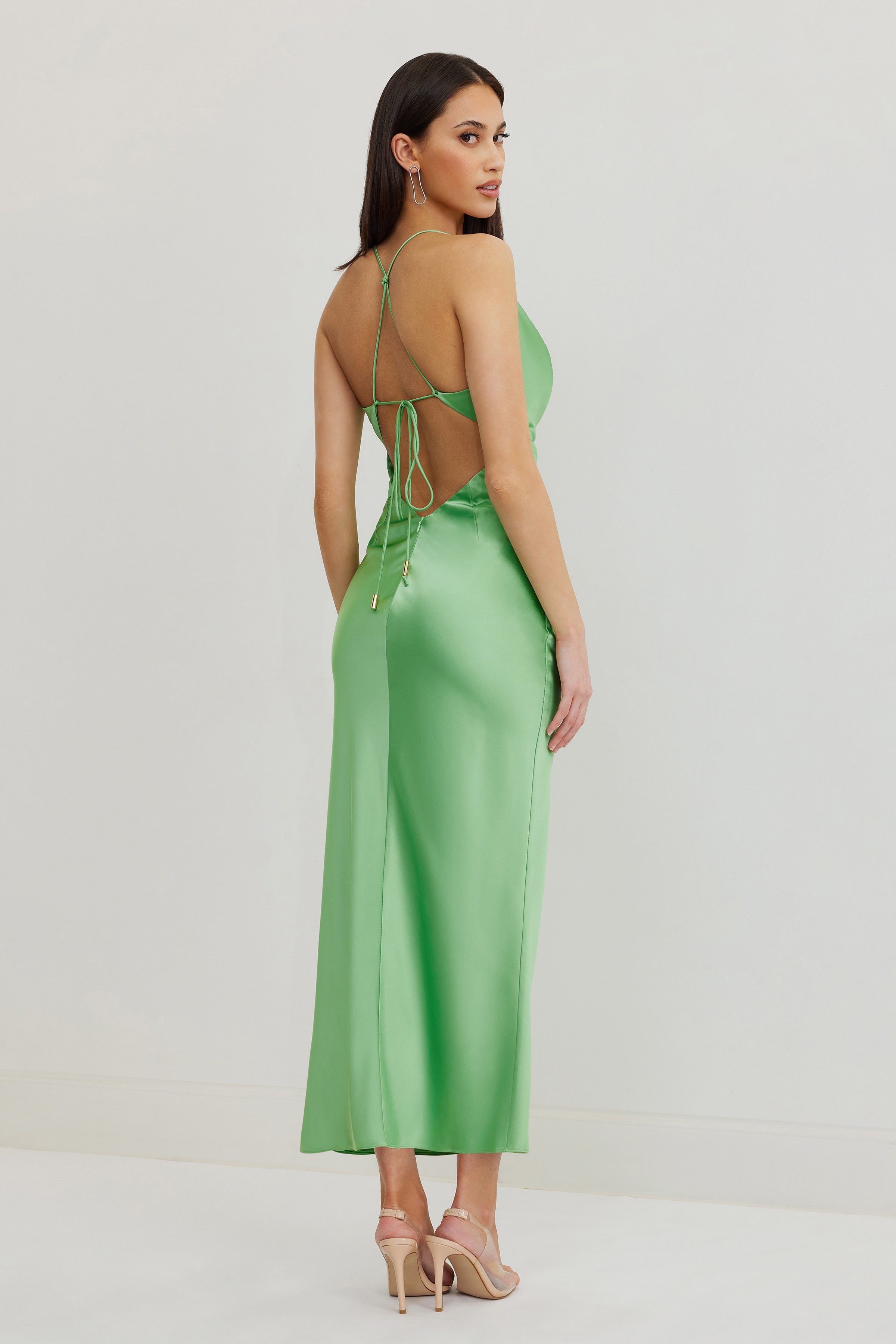 Dove Dress featuring a backless design with crisscross straps in luxurious kiwi green satin for elegant occasions