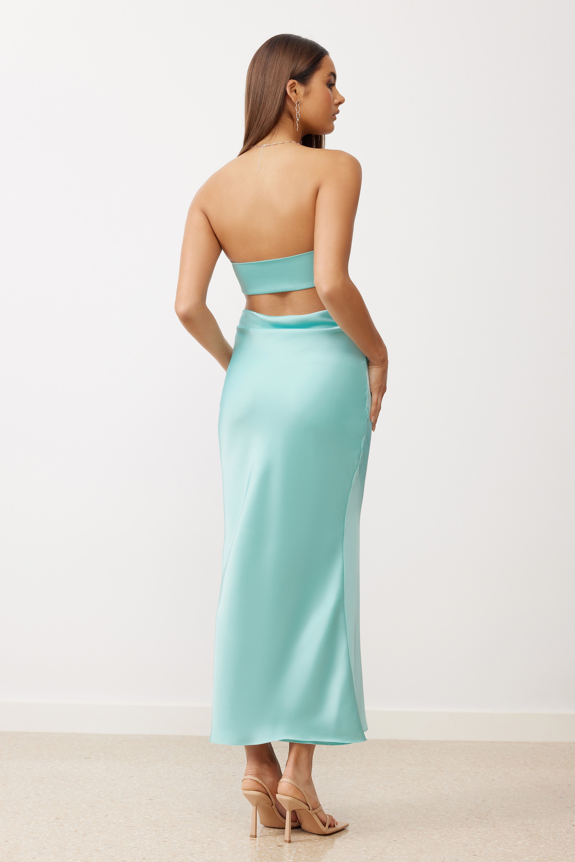 Indra Dress featuring a strapless backless design and sleek fit in aquamarine satin for formal and cocktail events