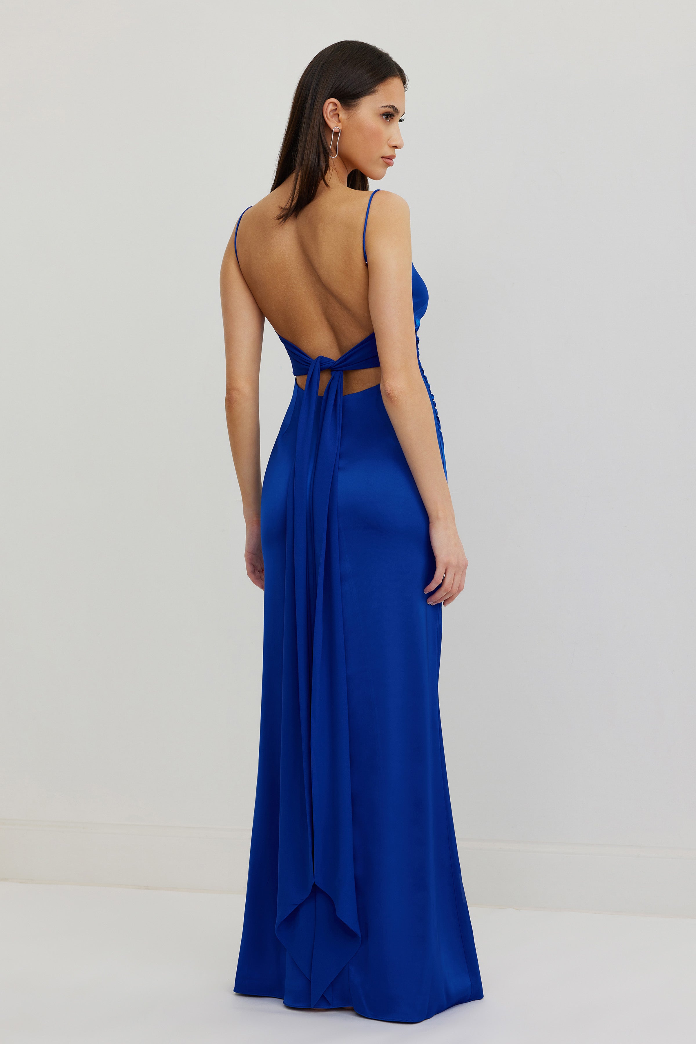 Ivy Dress featuring an elegant backless design with tie detail in cobalt blue satin for formal and black tie occasions