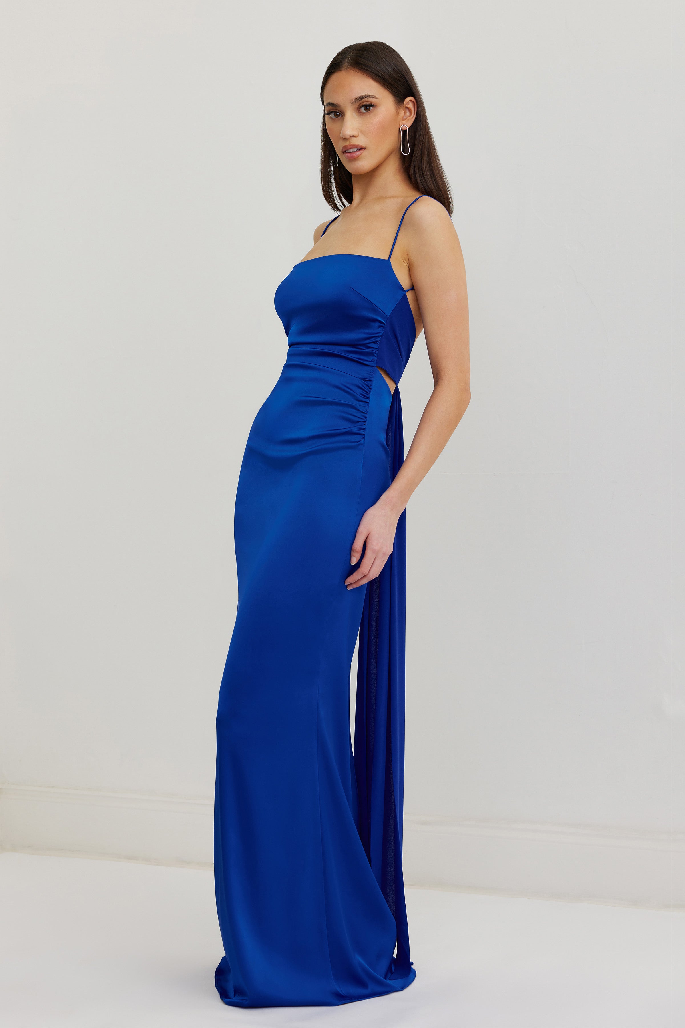 Ivy Dress featuring a sleek silhouette with thin straps and a backless design in vibrant cobalt satin for formal occasions