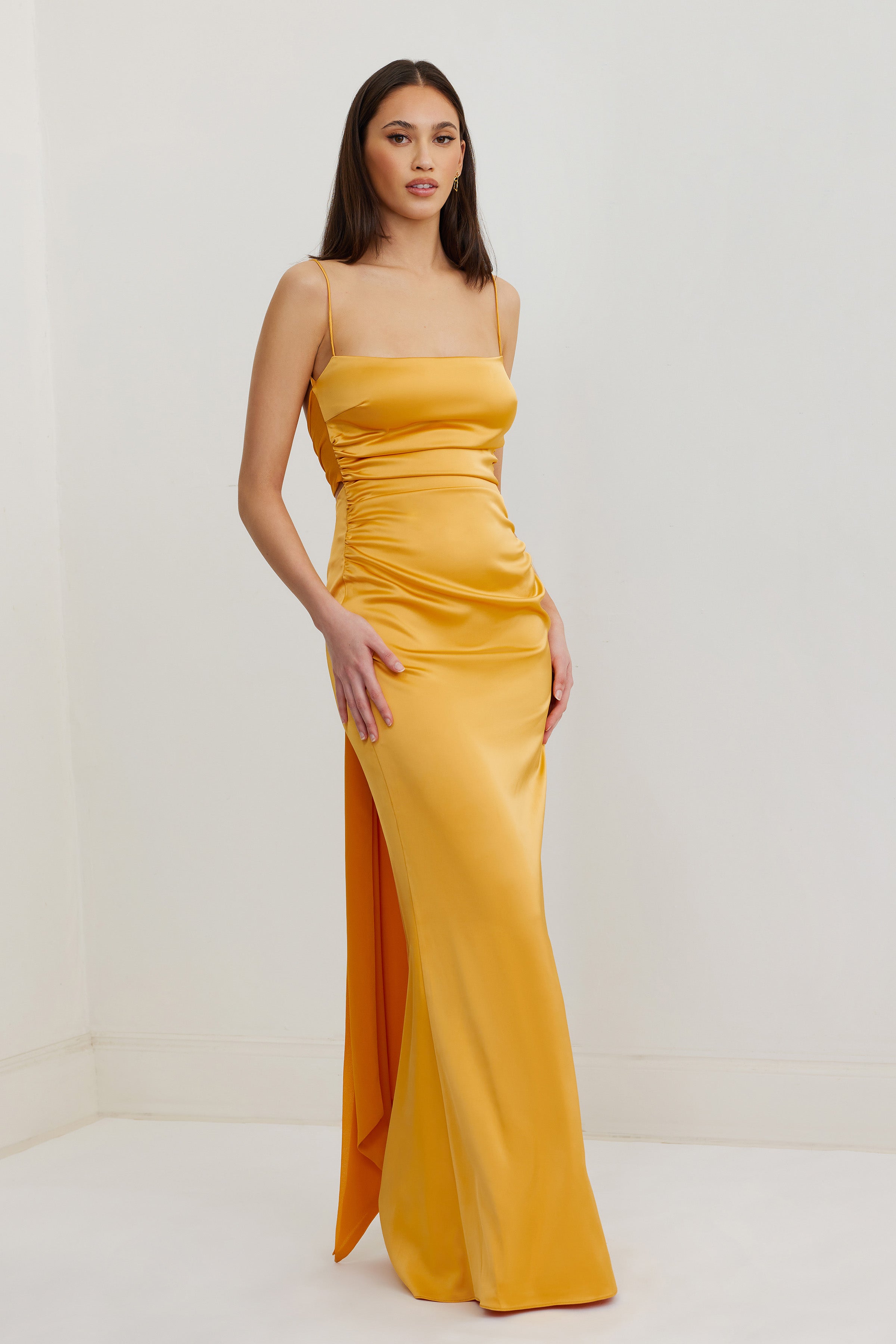 Ivy Dress featuring a sleek satin finish with slim straps and ruched sides in honey for formal and wedding guest wear