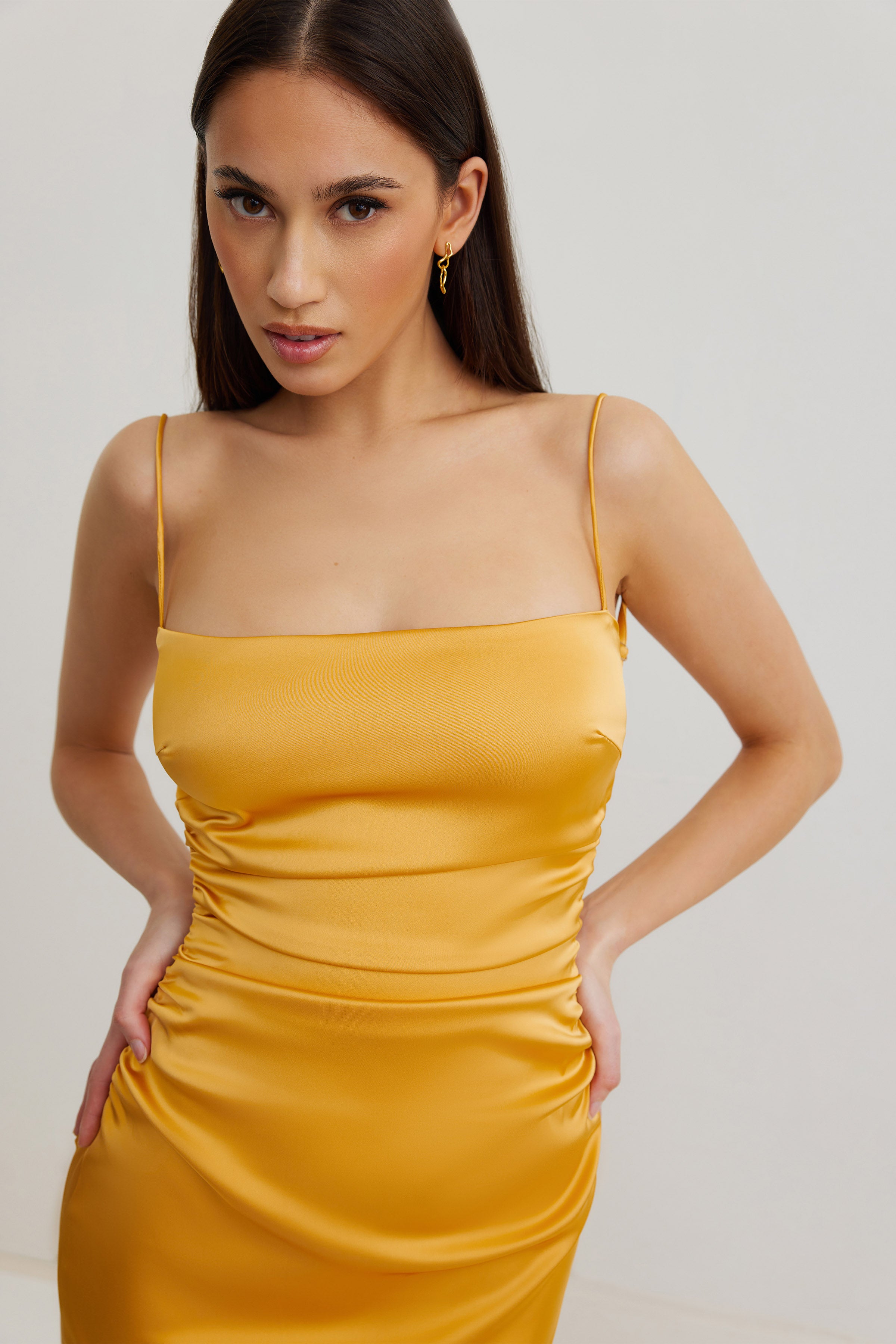 Ivy Dress featuring a sleek ruched silhouette with slim straps in honey for formal and wedding guest wear