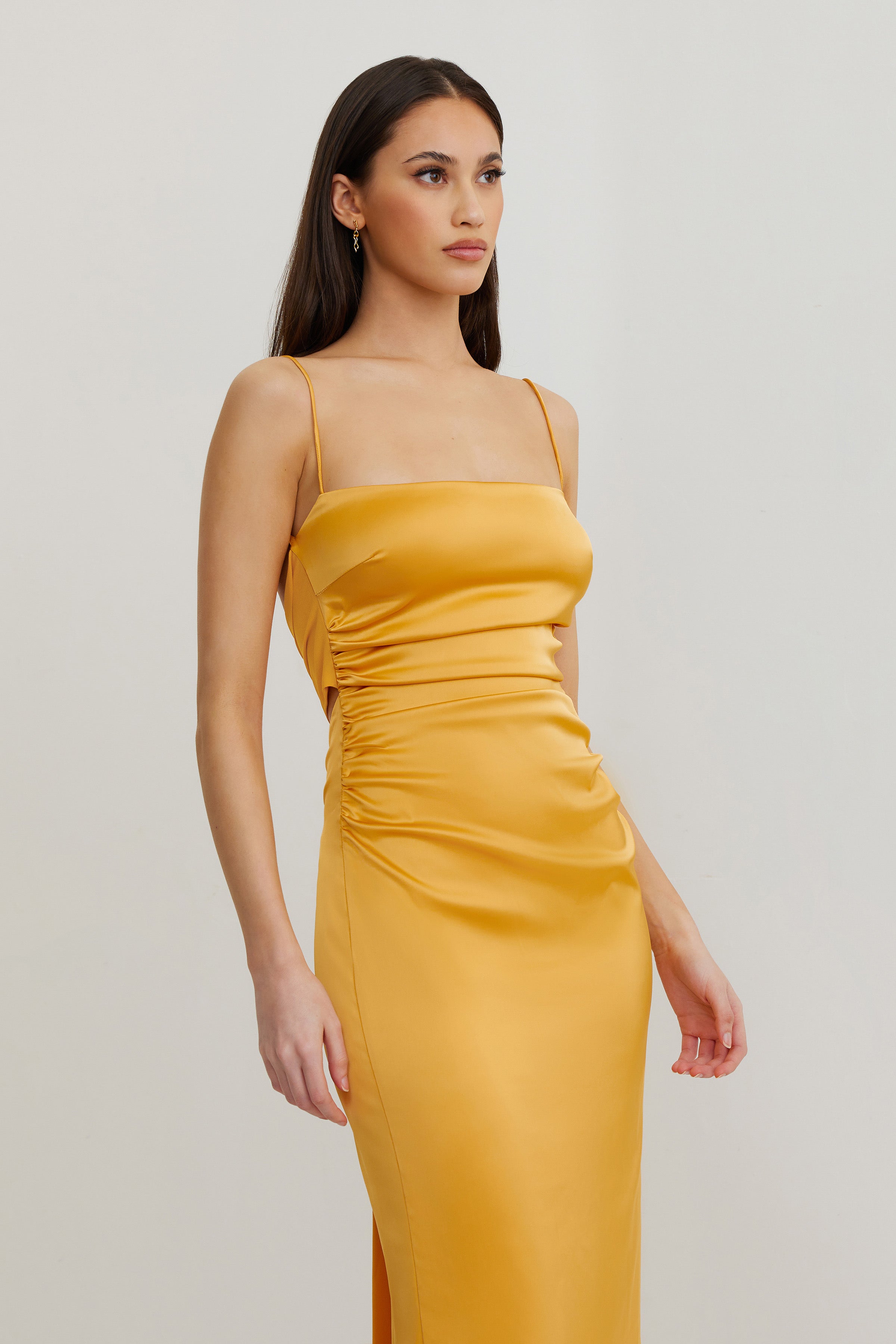 Ivy Dress featuring a sleek ruched silhouette with slim straps in honey for formal and wedding guest occasions