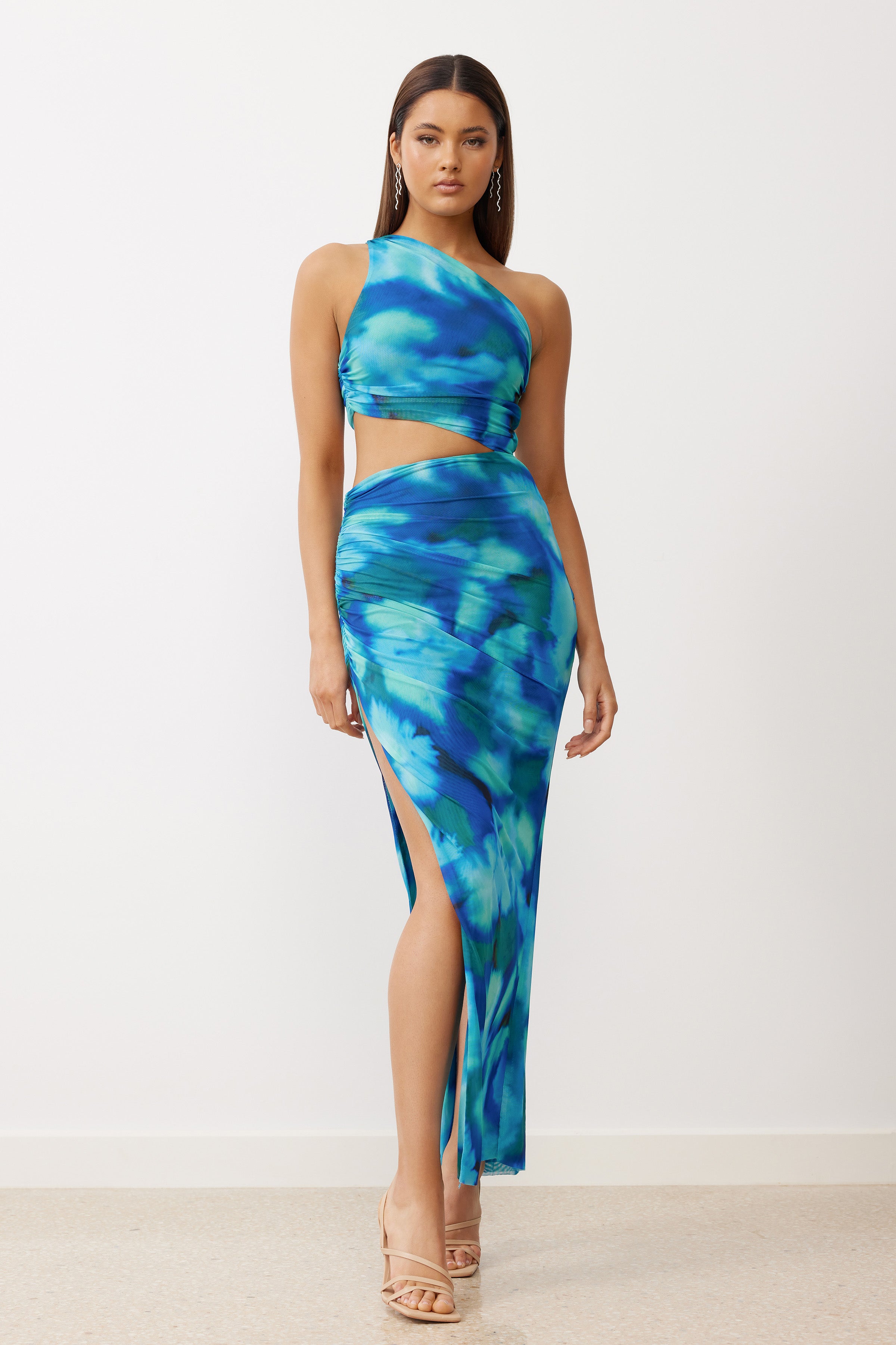 Kai Dress featuring a cut-out waist and high split in vibrant blue print for cocktail and formal occasions