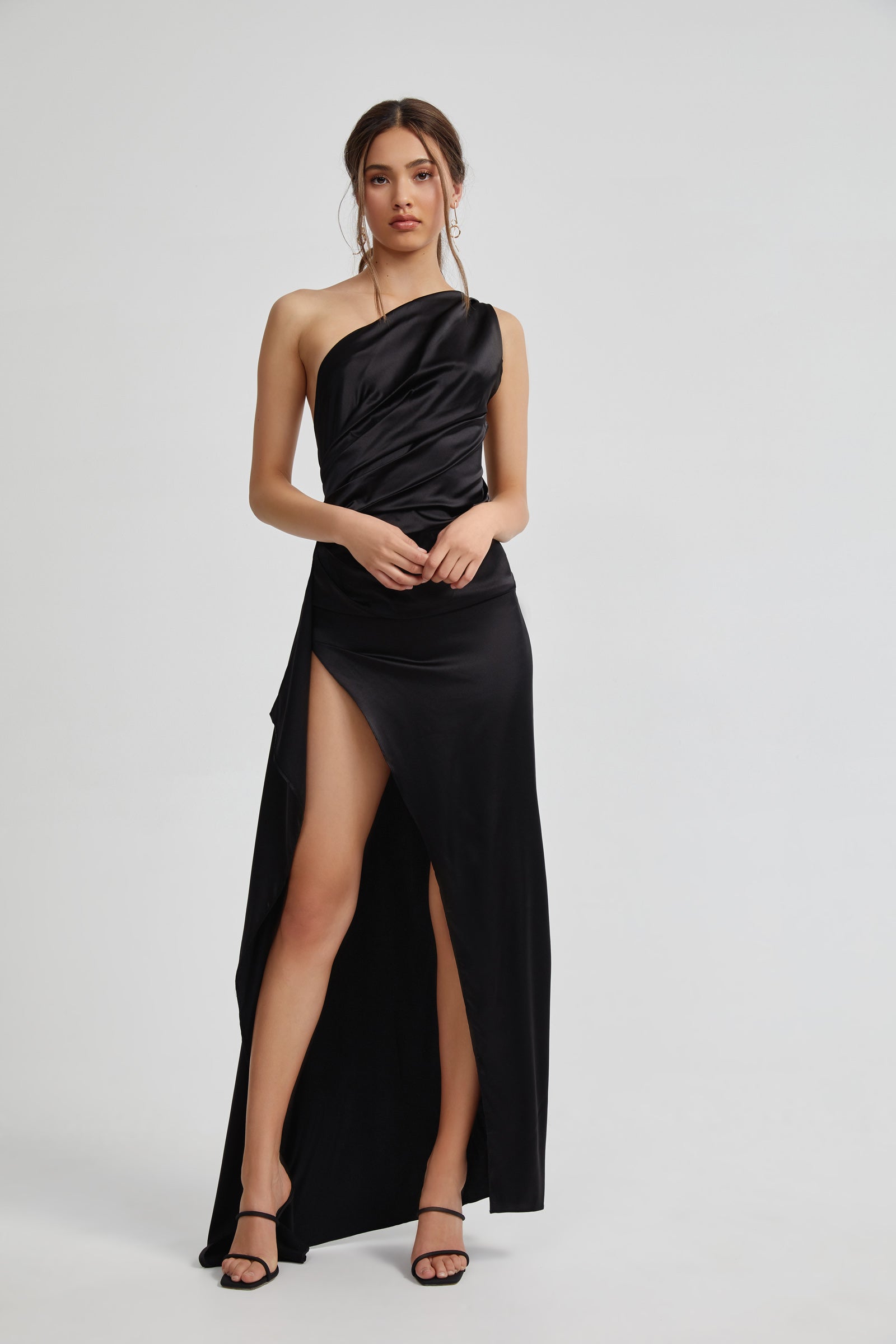 Samira Dress with draped one-shoulder design, ruched waist, and thigh-high split in black satin for formal black tie events