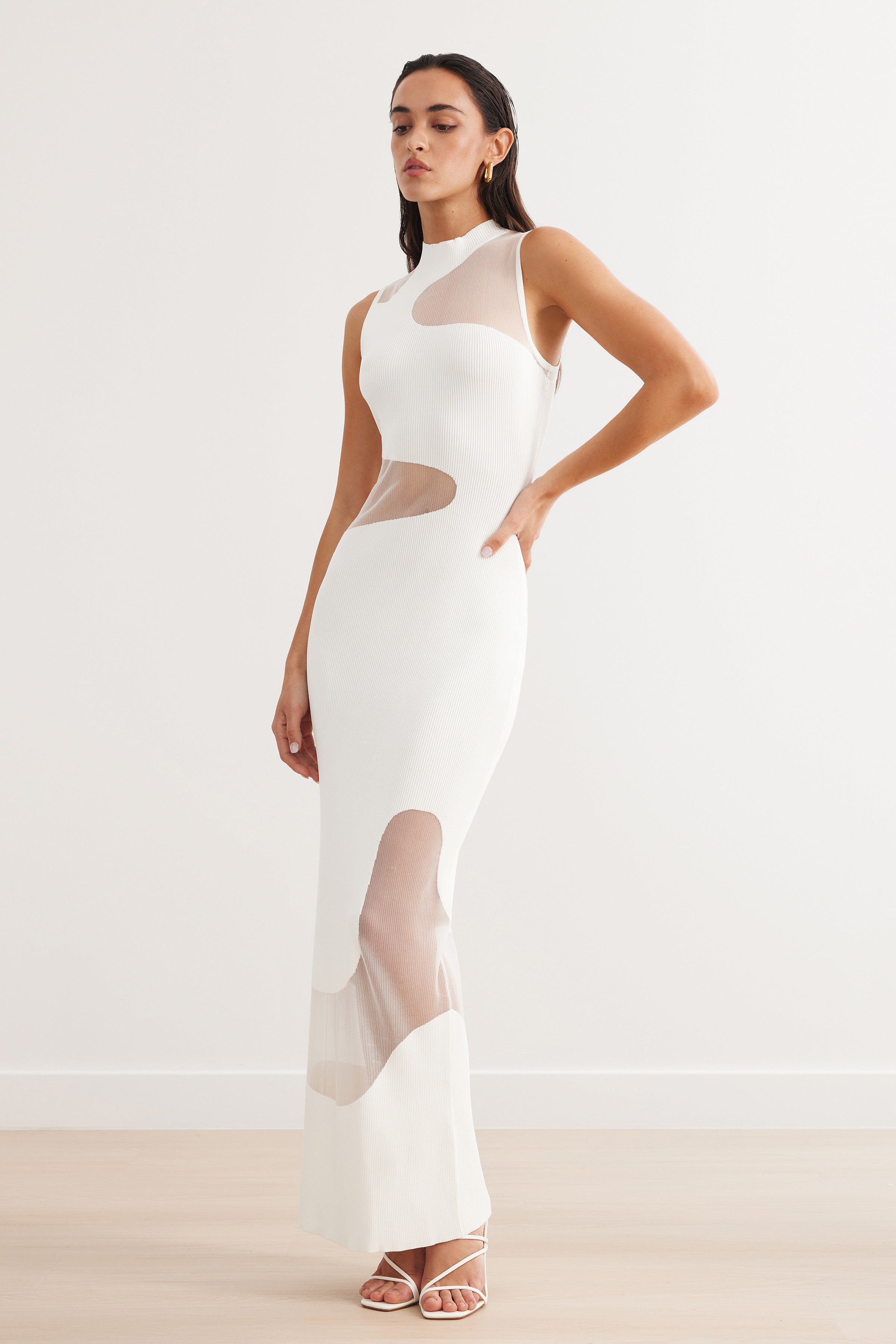 Sierra Dress with a sleeveless, fitted design featuring sheer ivory panels for elegant cocktail and party occasions