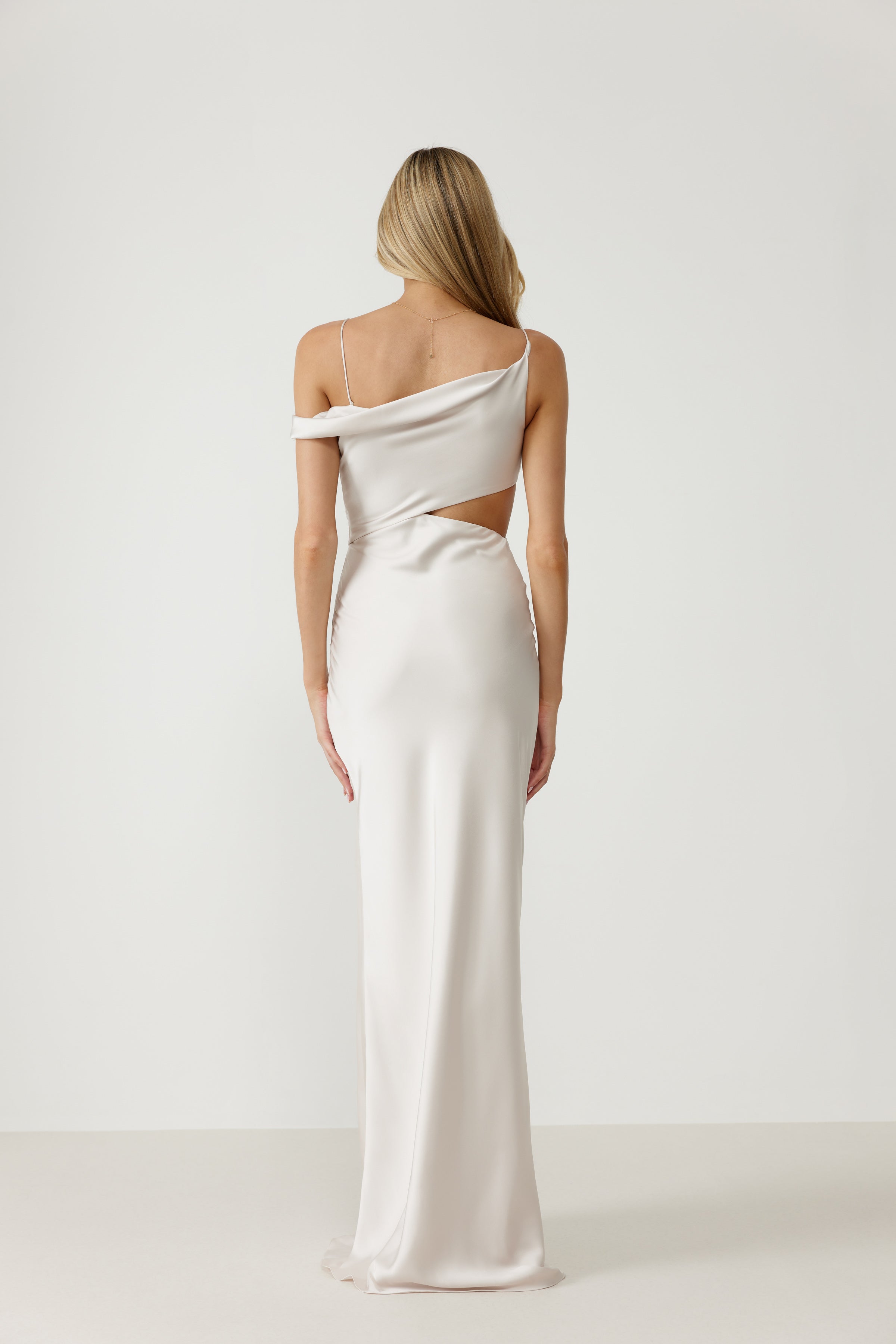 Zaria Dress featuring an off-shoulder sleeve with side cutout and thin strap in pearl satin for formal black tie occasions